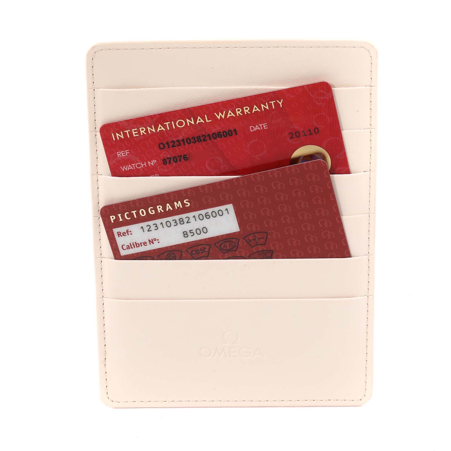 The image shows international warranty and pictogram cards for an Omega Constellation 123.10.38.21.06.001 Men's Stainless Steel Grey Dial 123.10.38.21.06.001 Men's Stainless Steel Grey Dial model watch in a beige cardholder.