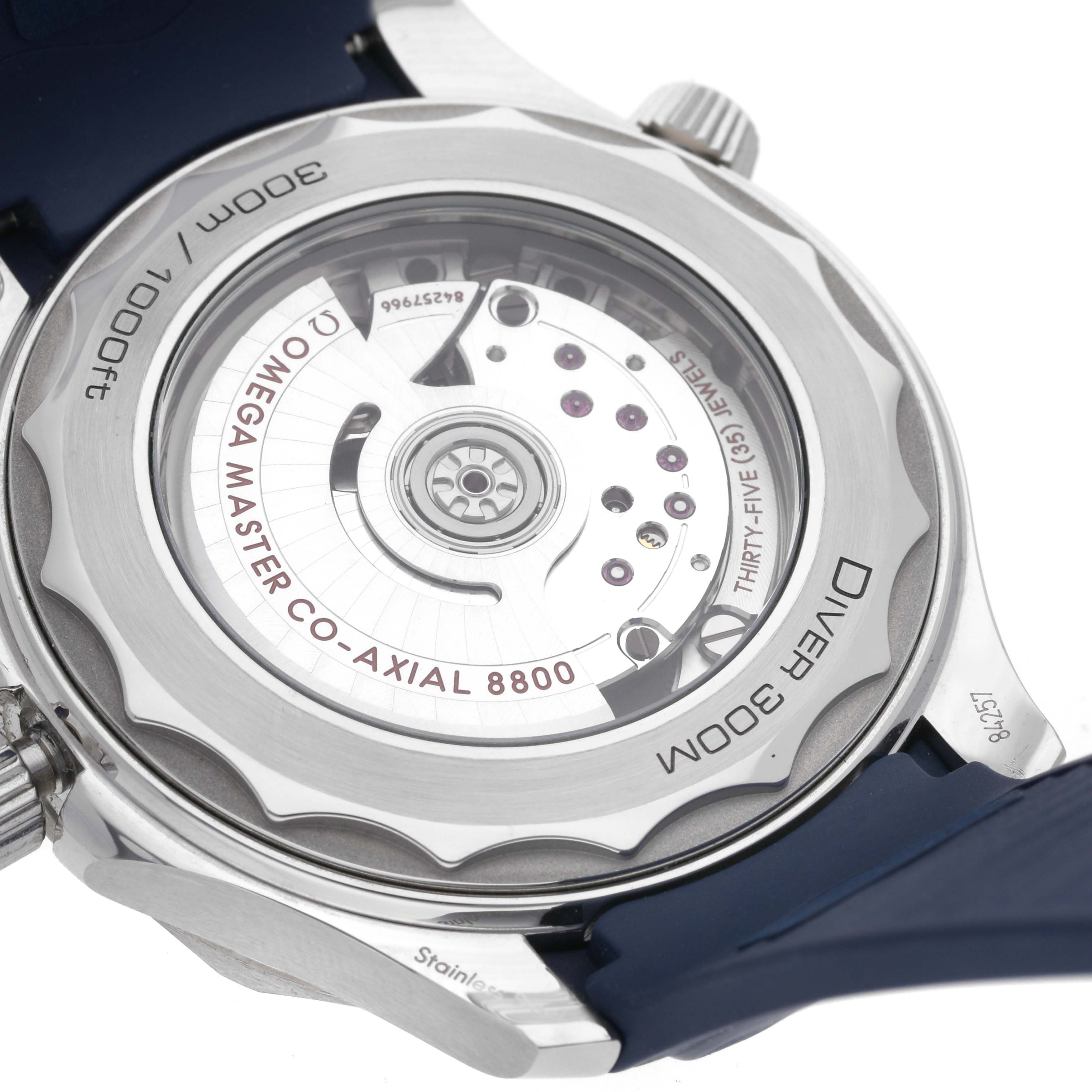 The image shows the back of an Omega Seamaster 210.32.42.20.03.001 Men
s Stainless Steel Blue Dial 210.32.42.20.03.001 Men
s Stainless Steel Blue Dial watch, highlighting the Omega Master Co-Axial 8800 movement in a close-up view.