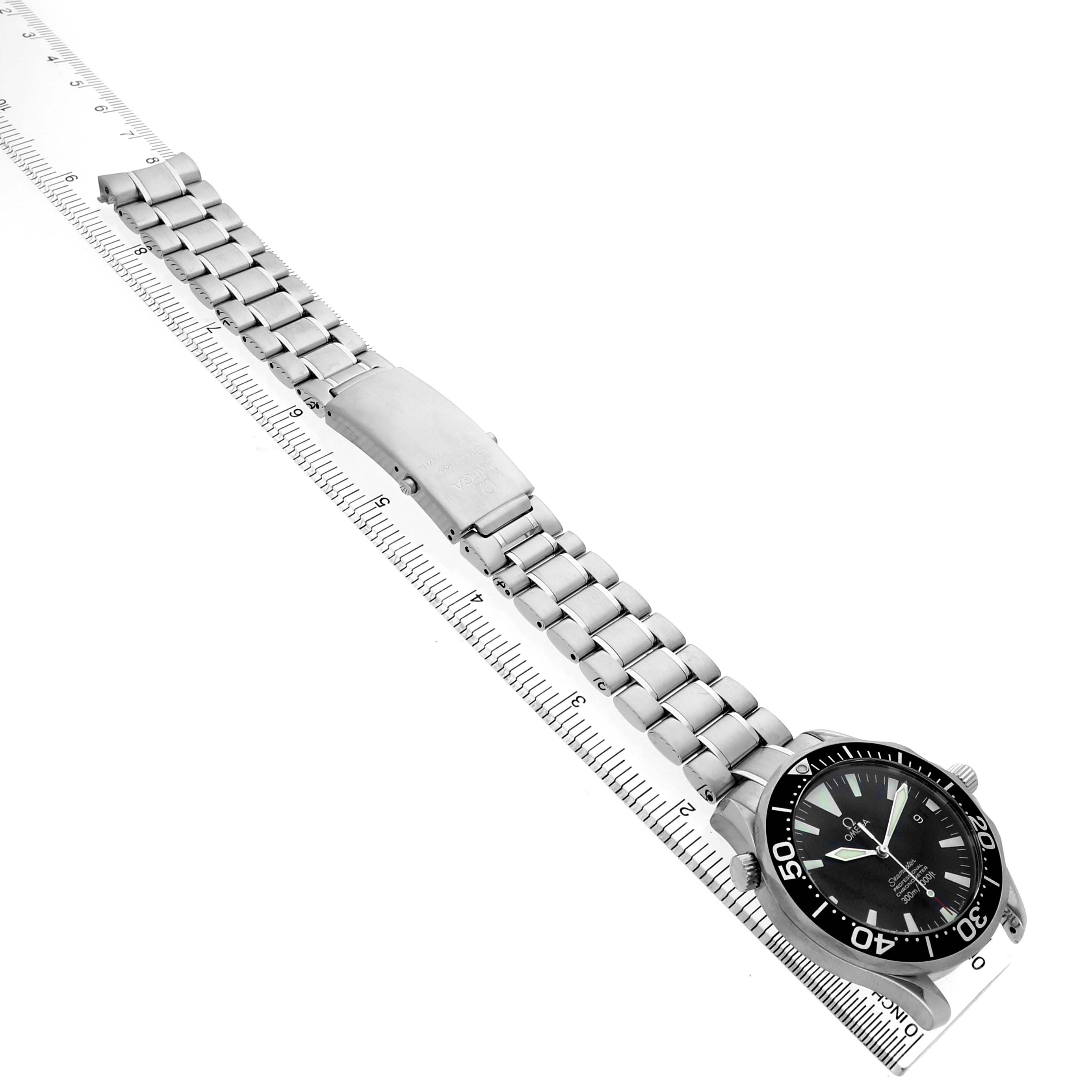 The Omega Seamaster 2254.50.00 Men's Stainless Steel Black Dial watch is shown at an angle with its bracelet laid flat alongside a ruler.