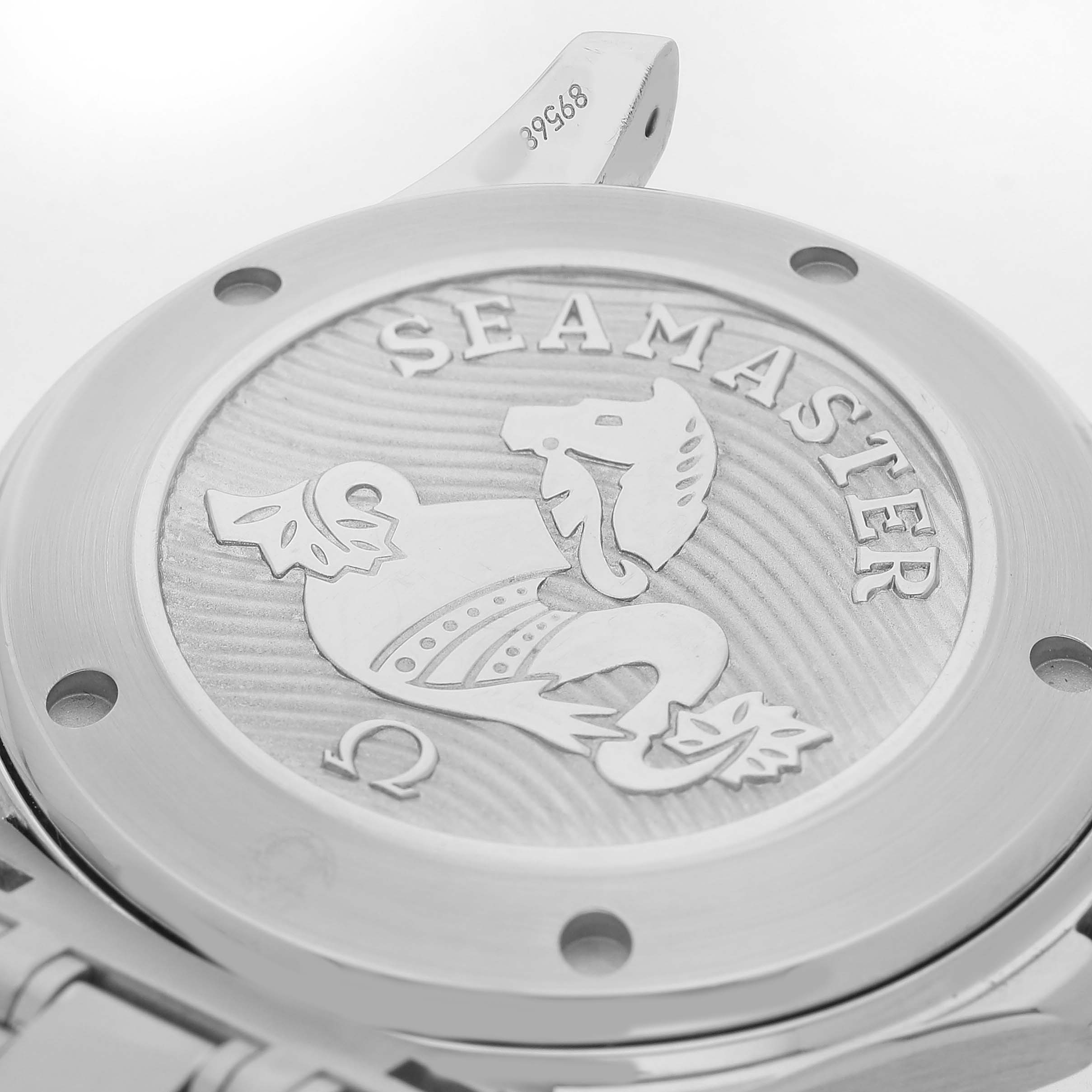 The image shows the back of an Omega Seamaster 212.30.41.20.03.001 Men's Stainless Steel Blue Dial watch, highlighting the engraved logo and serial number.
