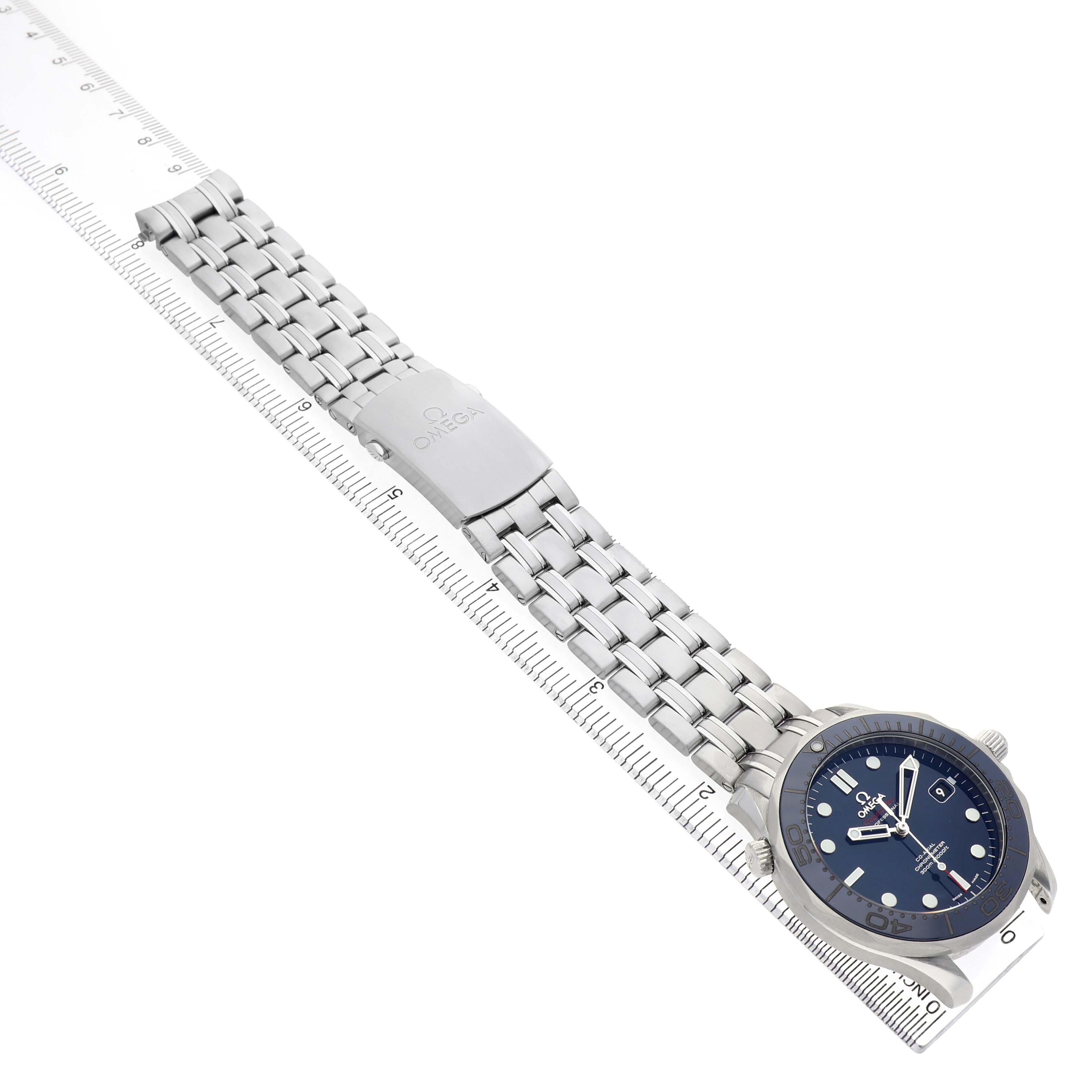 The image shows a side view of an Omega Seamaster 212.30.41.20.03.001 Men's Stainless Steel Blue Dial watch, highlighting its blue dial, bezel, and metal bracelet with clasp.