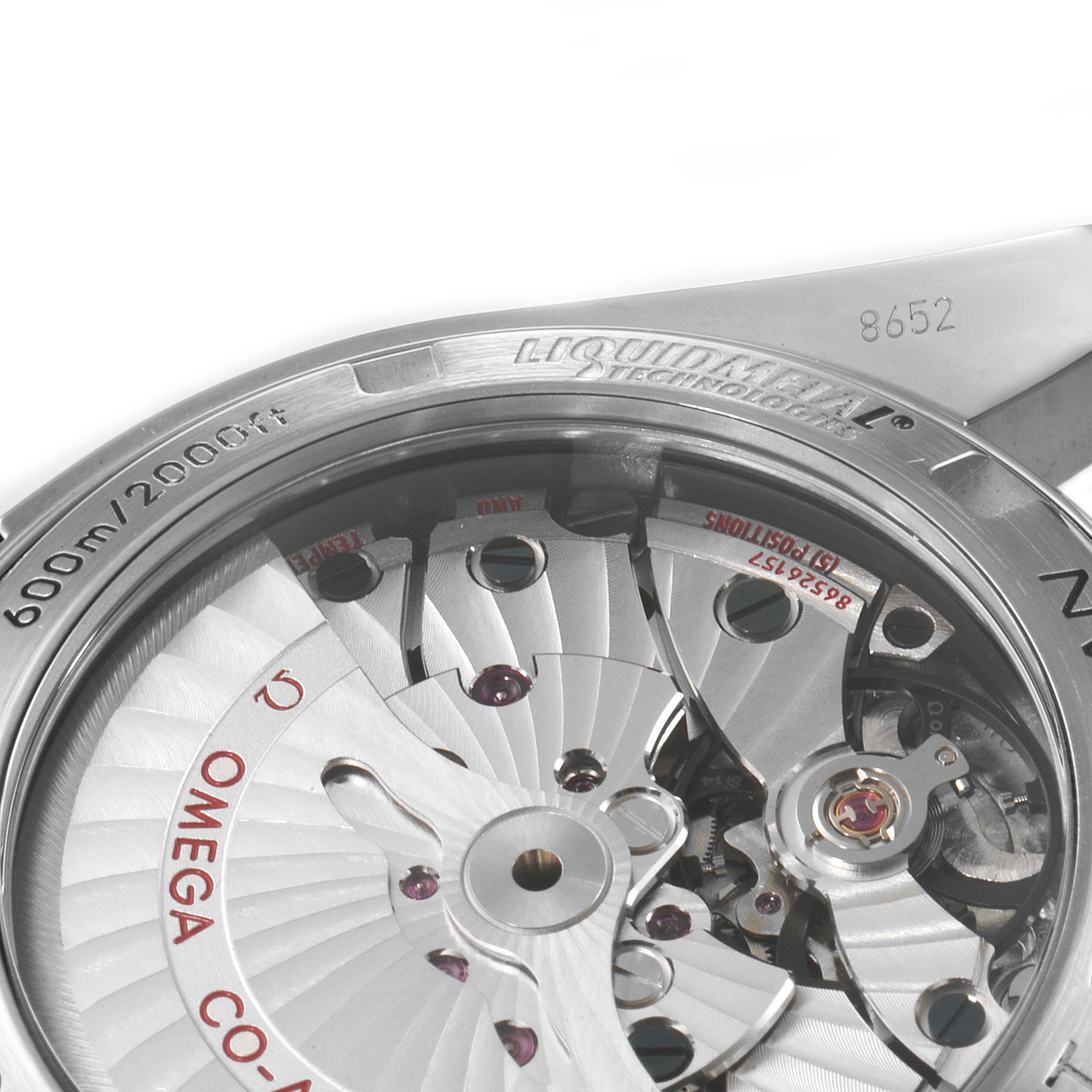 This image shows a close-up view of the intricate Omega Planet Ocean 232.90.42.21.03.001 Men's Titanium Blue Dial 232.90.42.21.03.001 Men's Titanium Blue Dial watch movement and part of its stainless steel caseback.