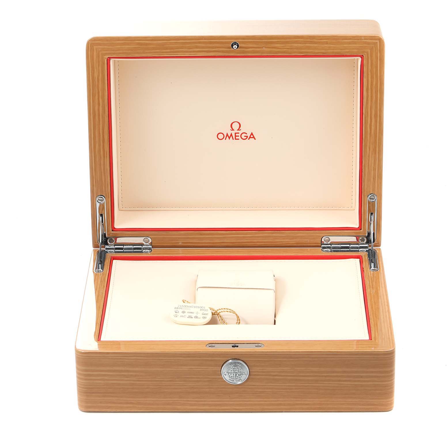 The image shows an open wooden presentation box for the Planet Ocean model by Omega, displaying the interior and a watch tag.