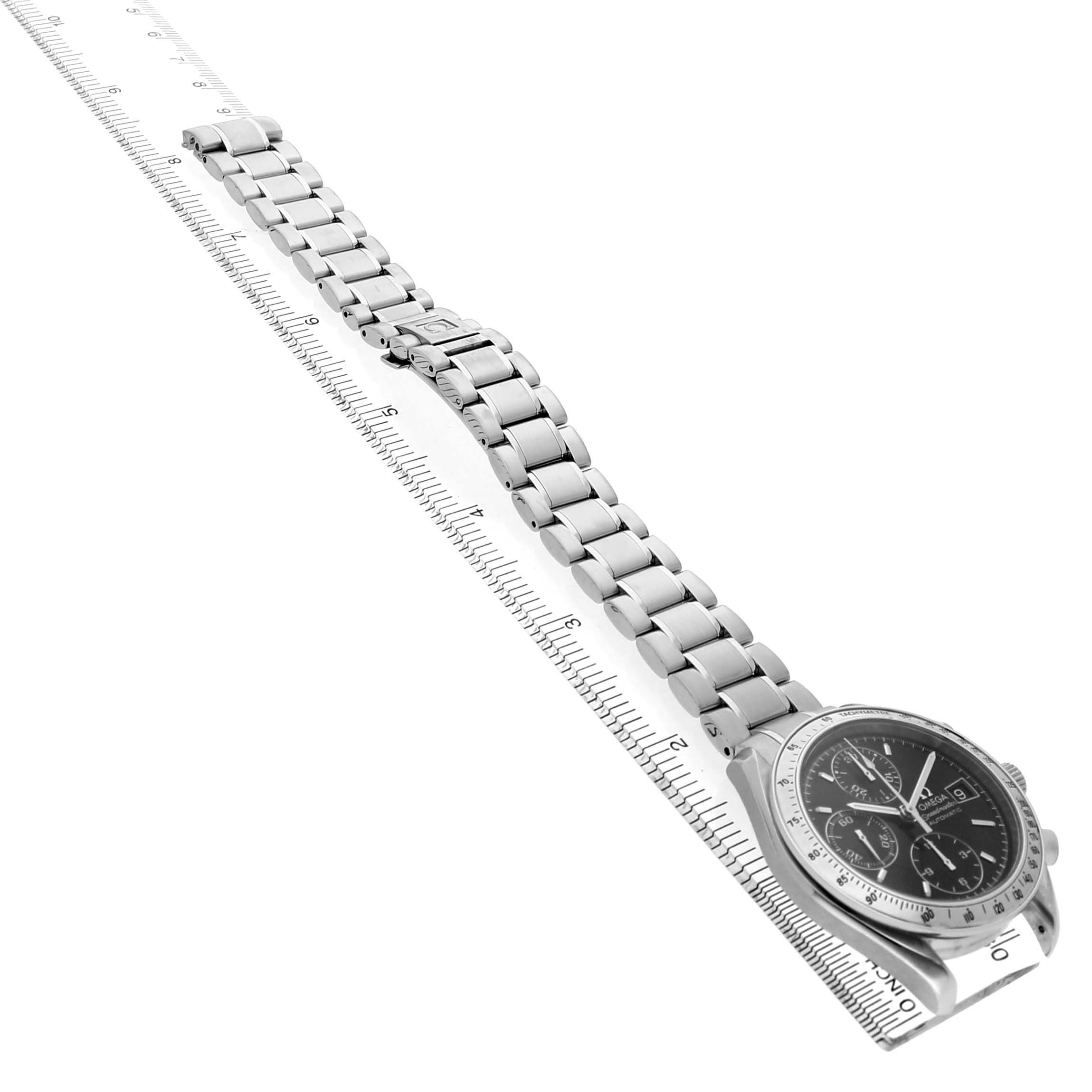 The Omega Speedmaster 3210.50.00 Men's Stainless Steel Black Dial watch is shown from a top-side angle, displaying the face, bezel, and full bracelet aligned with a ruler.