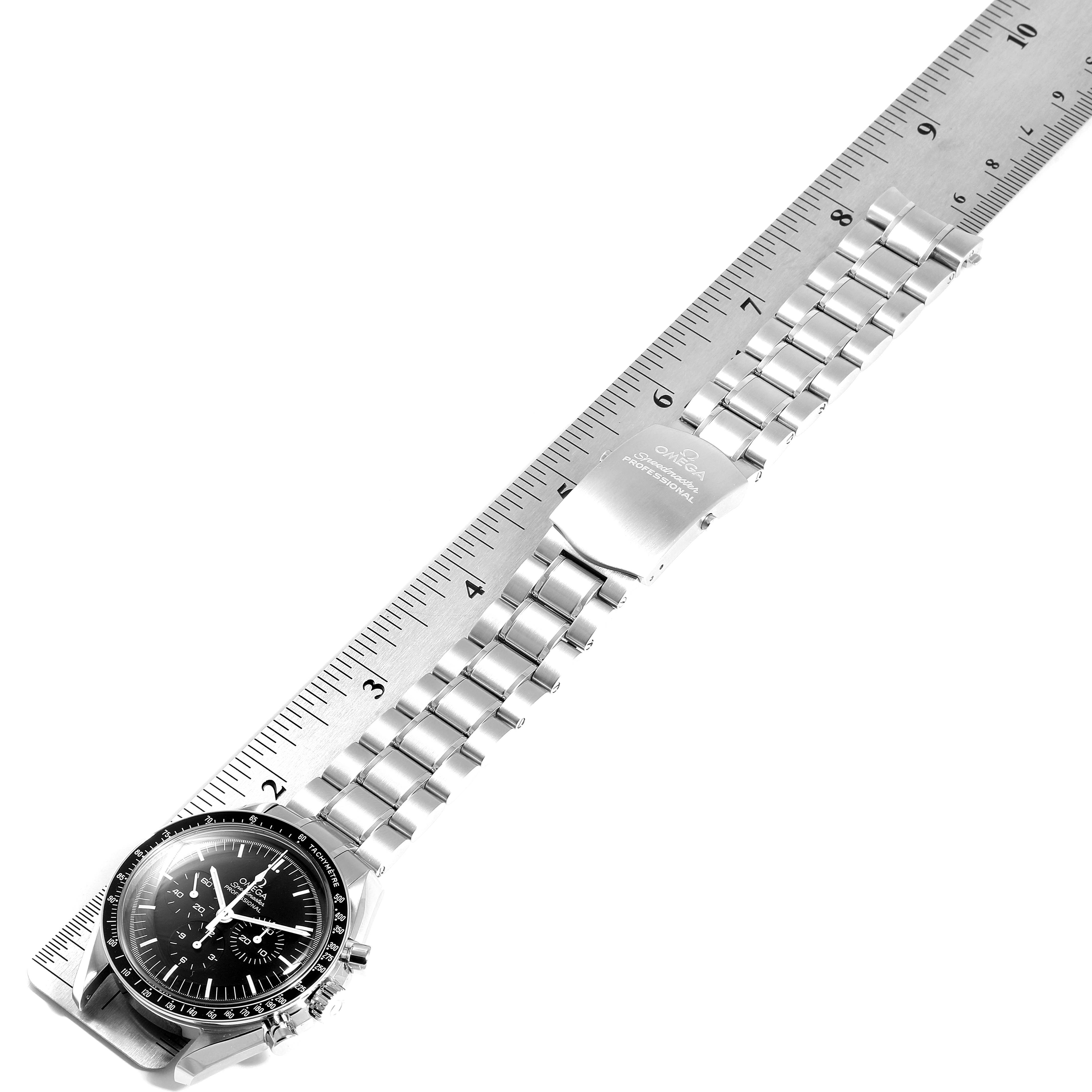 This image shows an Omega Speedmaster 311.30.42.30.01.005 Men
s Stainless Steel Black Dial 311.30.42.30.01.005 Men
s Stainless Steel Black Dial watch laid flat with its bracelet alongside a ruler for measurement.