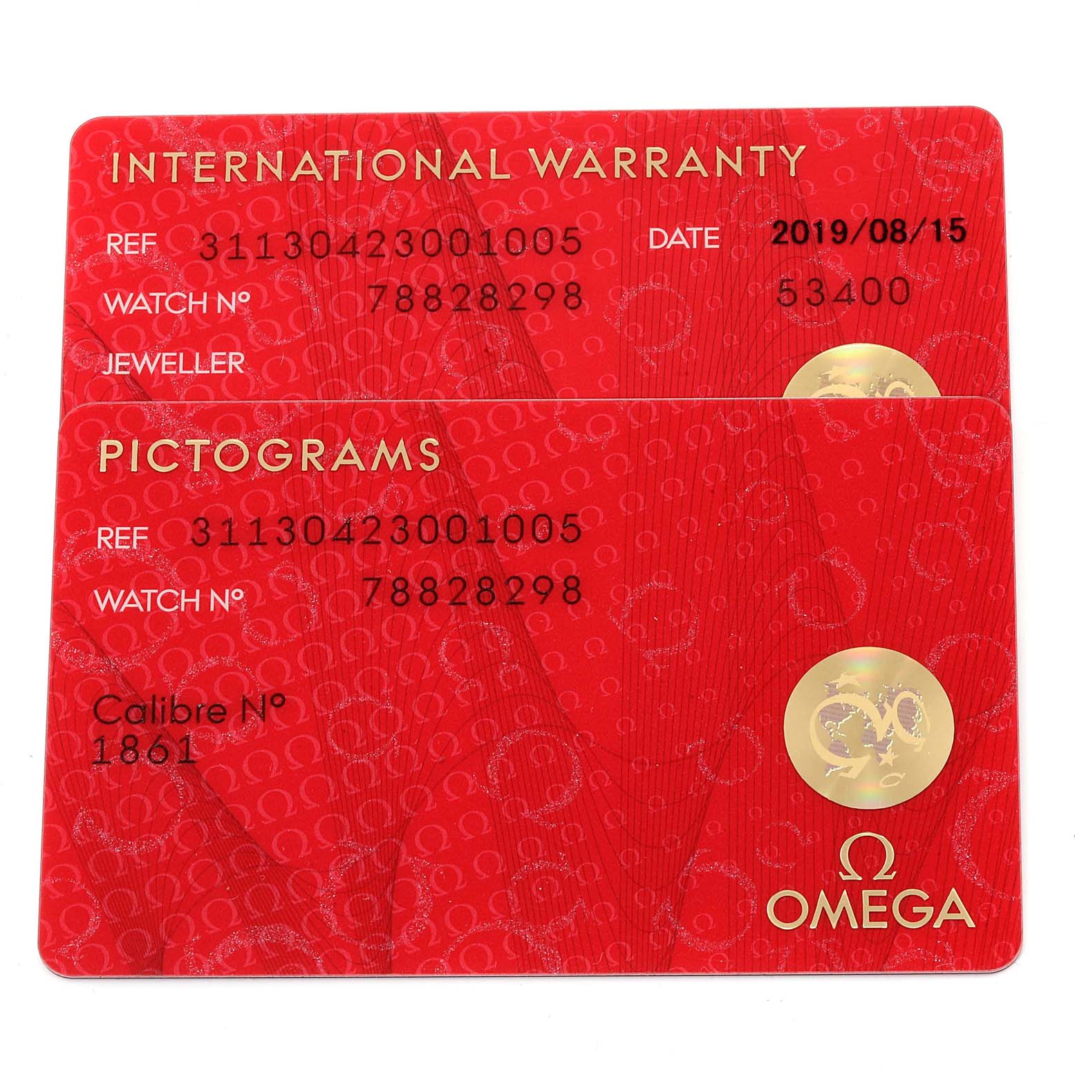 The image shows international warranty and pictogram cards for an Omega Speedmaster 311.30.42.30.01.005 Men
s Stainless Steel Black Dial 311.30.42.30.01.005 Men
s Stainless Steel Black Dial watch, laying flat.