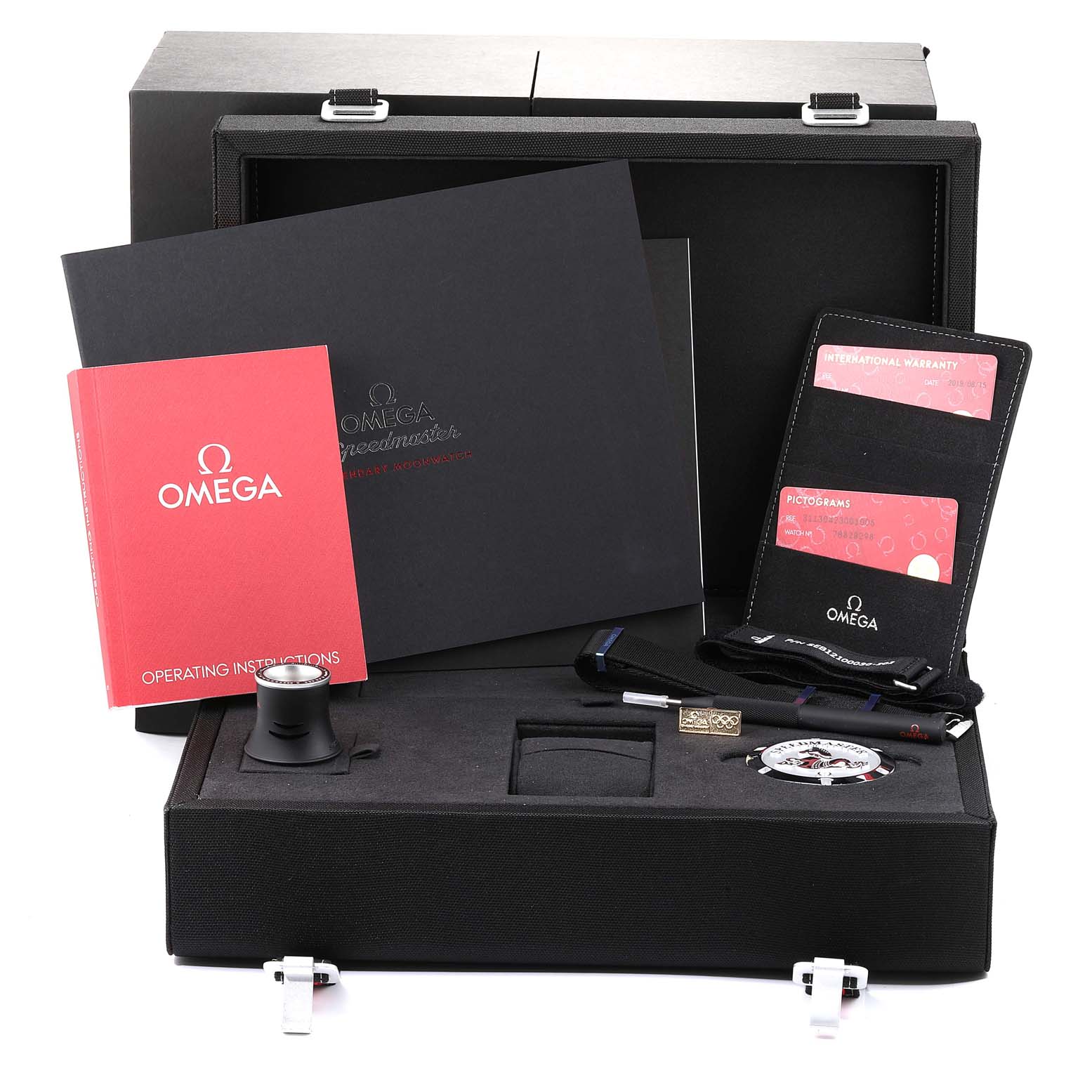 The image shows the accessories for an Omega Speedmaster 311.30.42.30.01.005 Men
s Stainless Steel Black Dial 311.30.42.30.01.005 Men
s Stainless Steel Black Dial, including the box, manuals, warranty cards, and additional tools.