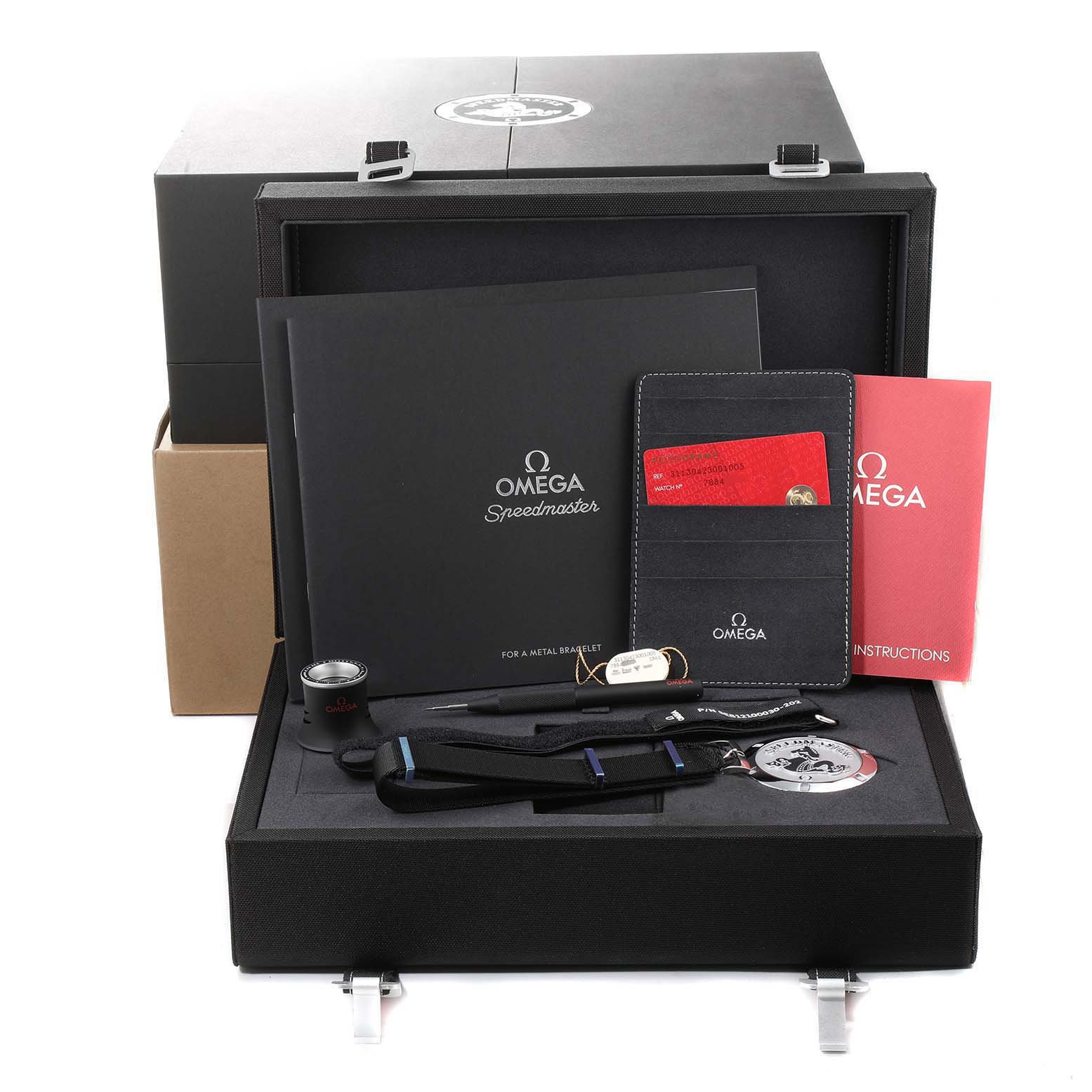 The image shows an Omega Speedmaster 311.30.42.30.01.005 Men
s Stainless Steel Black Dial 311.30.42.30.01.005 Men
s Stainless Steel Black Dial watch box set with documents, a strap, cards, and tools.