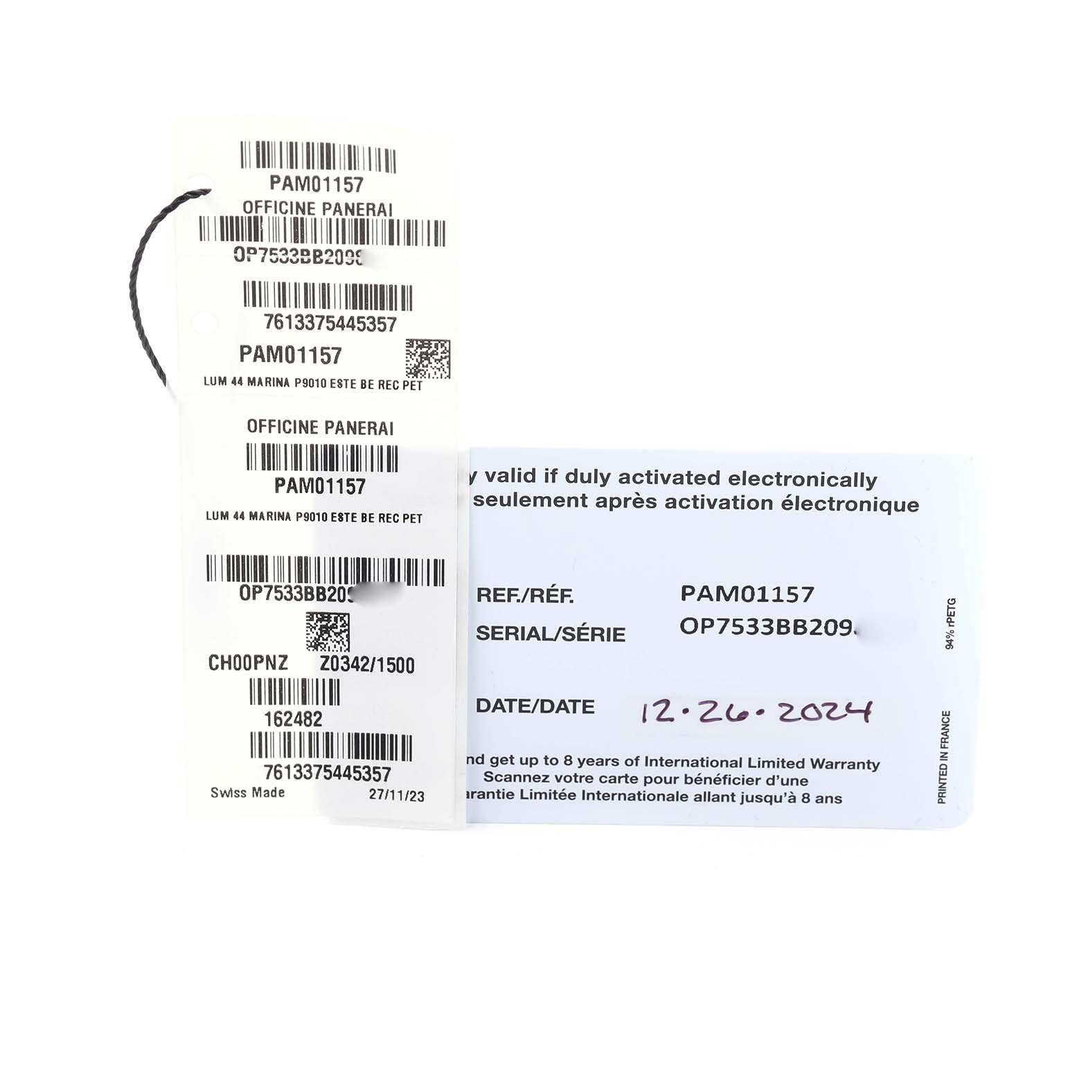 The image shows tags and paperwork for the Panerai Luminor PAM01157 Men
s Stainless Steel Blue Dial PAM01157 Men
s Stainless Steel Blue Dial model, including reference and serial numbers.