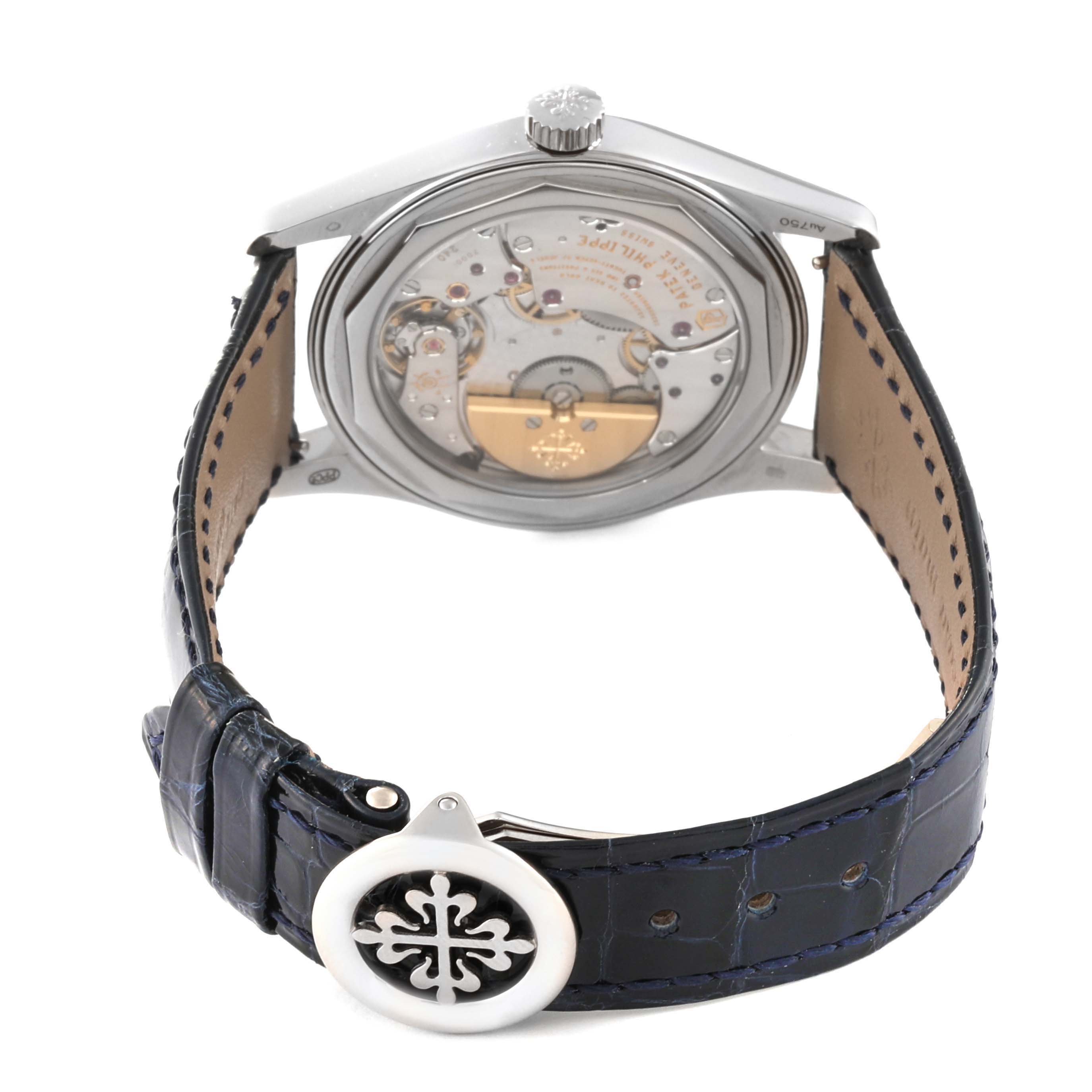 The image shows the back view of a Patek Philippe Calatrava 6000G-012 Men's White Gold Blue Dial 6000G-012 Men's White Gold Blue Dial watch, displaying its movement and partially open leather strap.