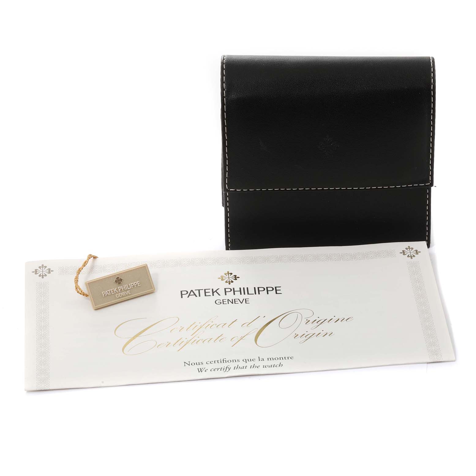 The image shows a Patek Philippe Calatrava 6000G-012 Men's White Gold Blue Dial 6000G-012 Men's White Gold Blue Dial watch's leather case, certificate of origin, and a tag, viewed from the front.