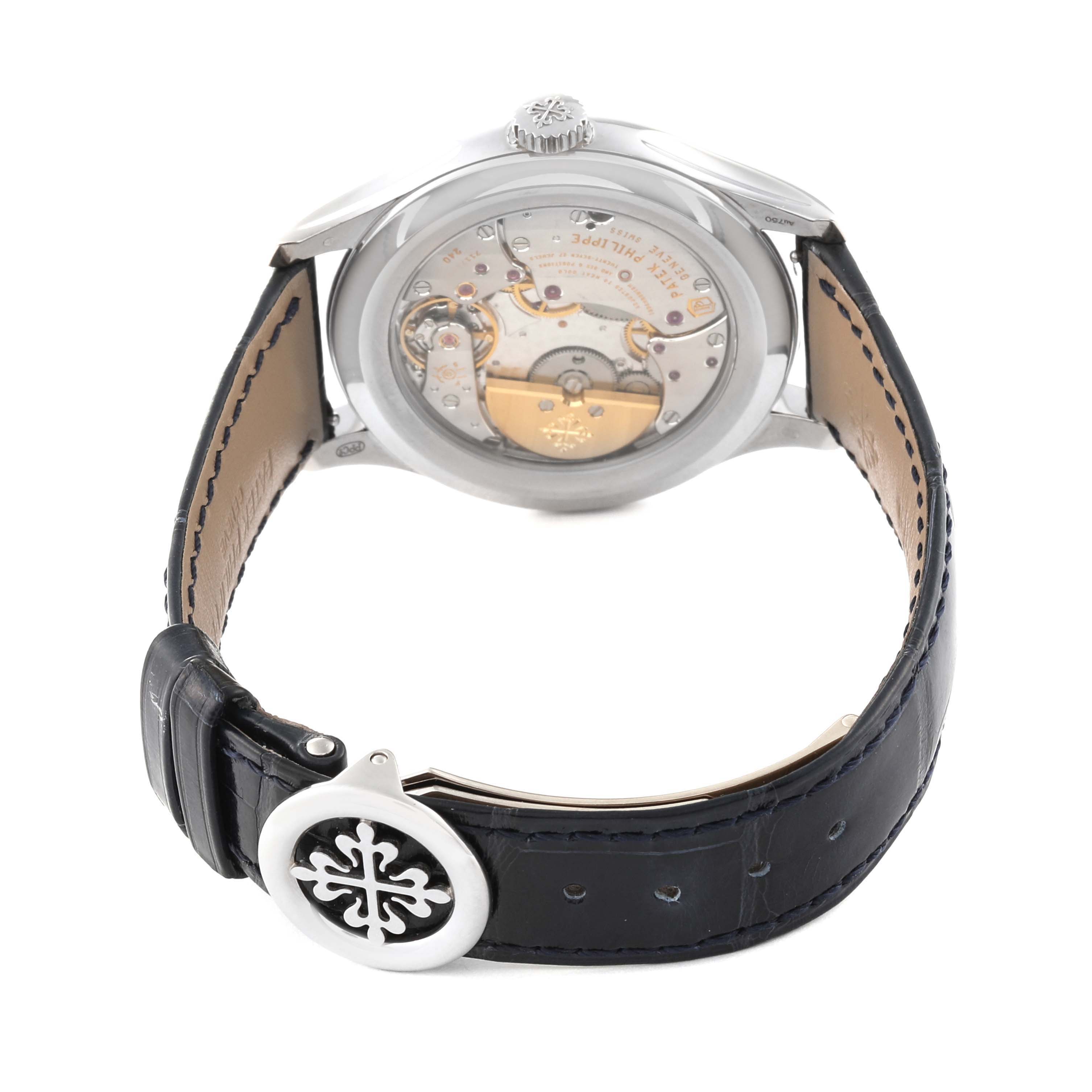 The image shows the back view of a Patek Philippe Complications 5327G-001 Men's White Gold Blue Dial 5327G-001 Men's White Gold Blue Dial watch, displaying its movement and part of the leather strap. 