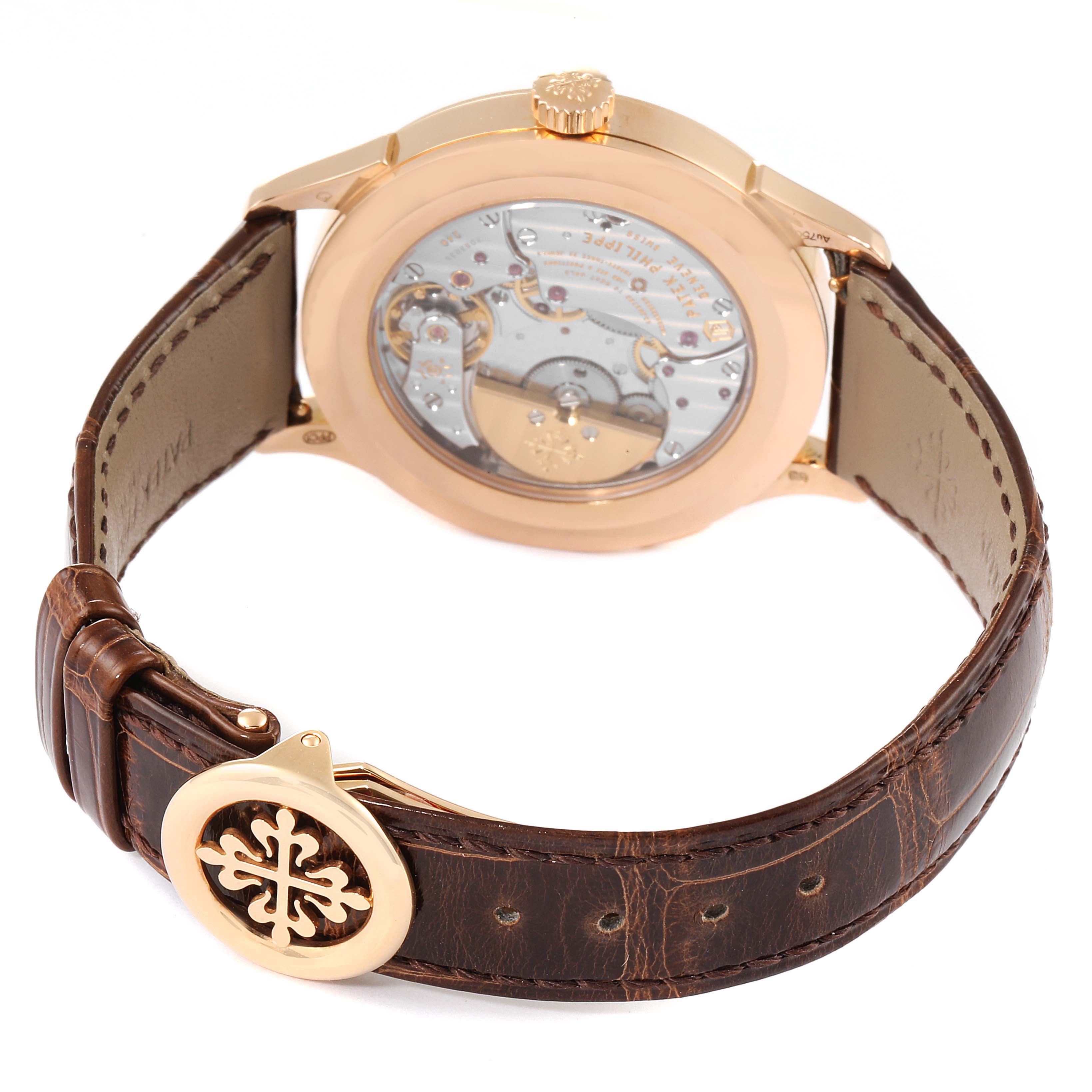 The image shows the back view of a Patek Philippe Complications 5230R Men's Rose Gold Grey Dial 5230R Men's Rose Gold Grey Dial watch, highlighting the transparent case back and the leather strap with a gold clasp.