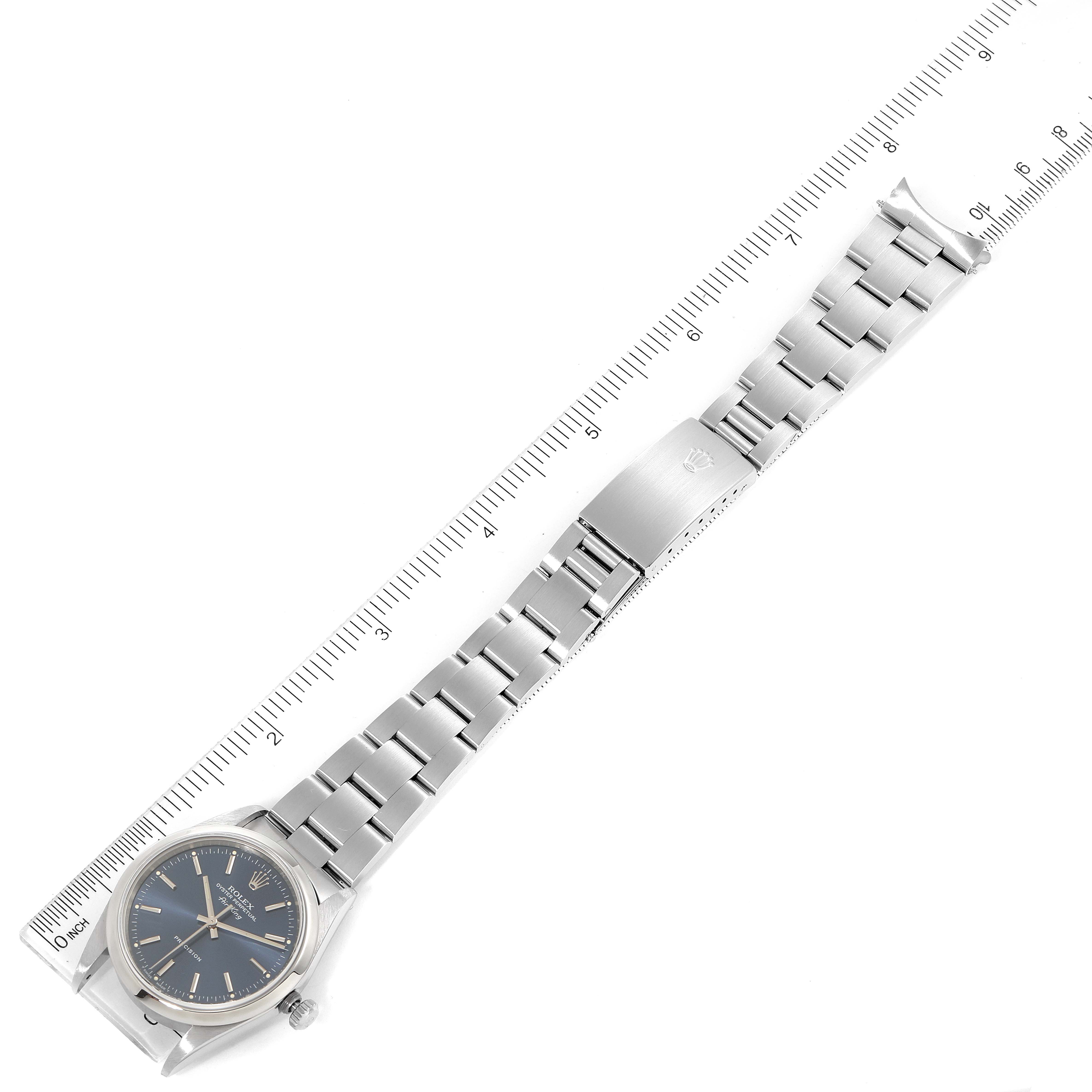 The image shows a Rolex Air-King 14000 Men's Stainless Steel Blue Dial 14000 Men's Stainless Steel Blue Dial watch laid flat, showcasing its face, bracelet, and clasp, alongside a ruler for scale.