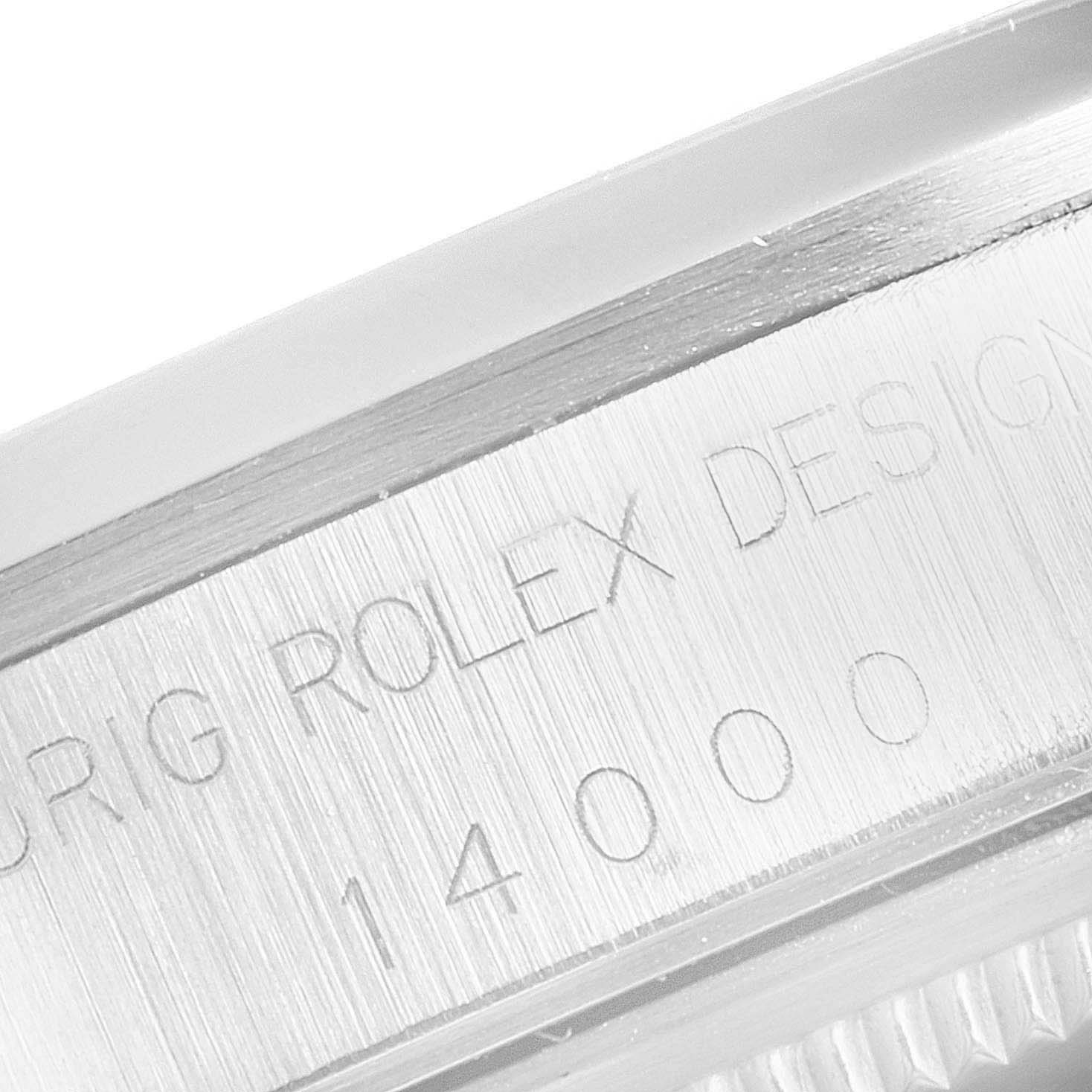 The image shows a close-up of the Rolex Air-King 14000 Men's Stainless Steel Pink Dial 14000 Men's Stainless Steel Pink Dial model case and its engraved "ROLEX DESIGN 14000" serial number.