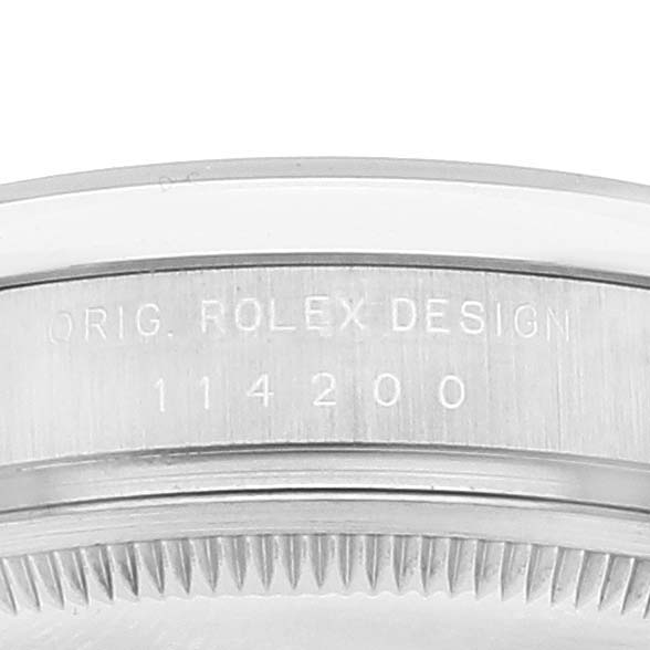 This close-up image shows the engraved model number and part of a Rolex Air-King 114200 Men's Stainless Steel Pink Dial 114200 Men's Stainless Steel Pink Dial case.