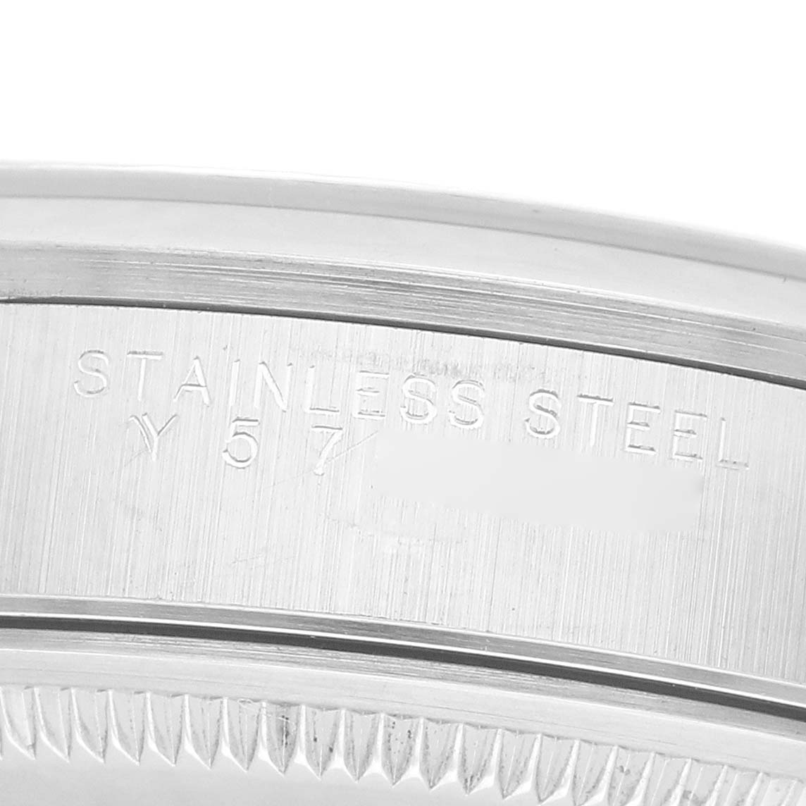 The image shows a close-up of the Rolex Air-King 14000M Men's Stainless Steel Black Dial's stainless steel case with engraved markings.