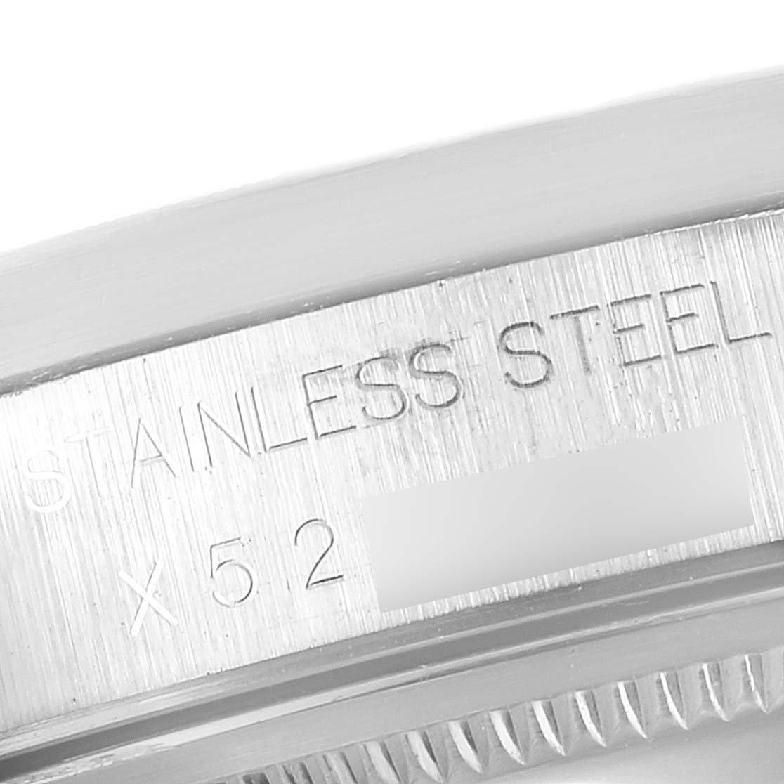 This close-up image shows the edge of the stainless steel case back of a Rolex Air-King 14010 Men's Stainless Steel Silver Dial 14010 Men's Stainless Steel Silver Dial watch.