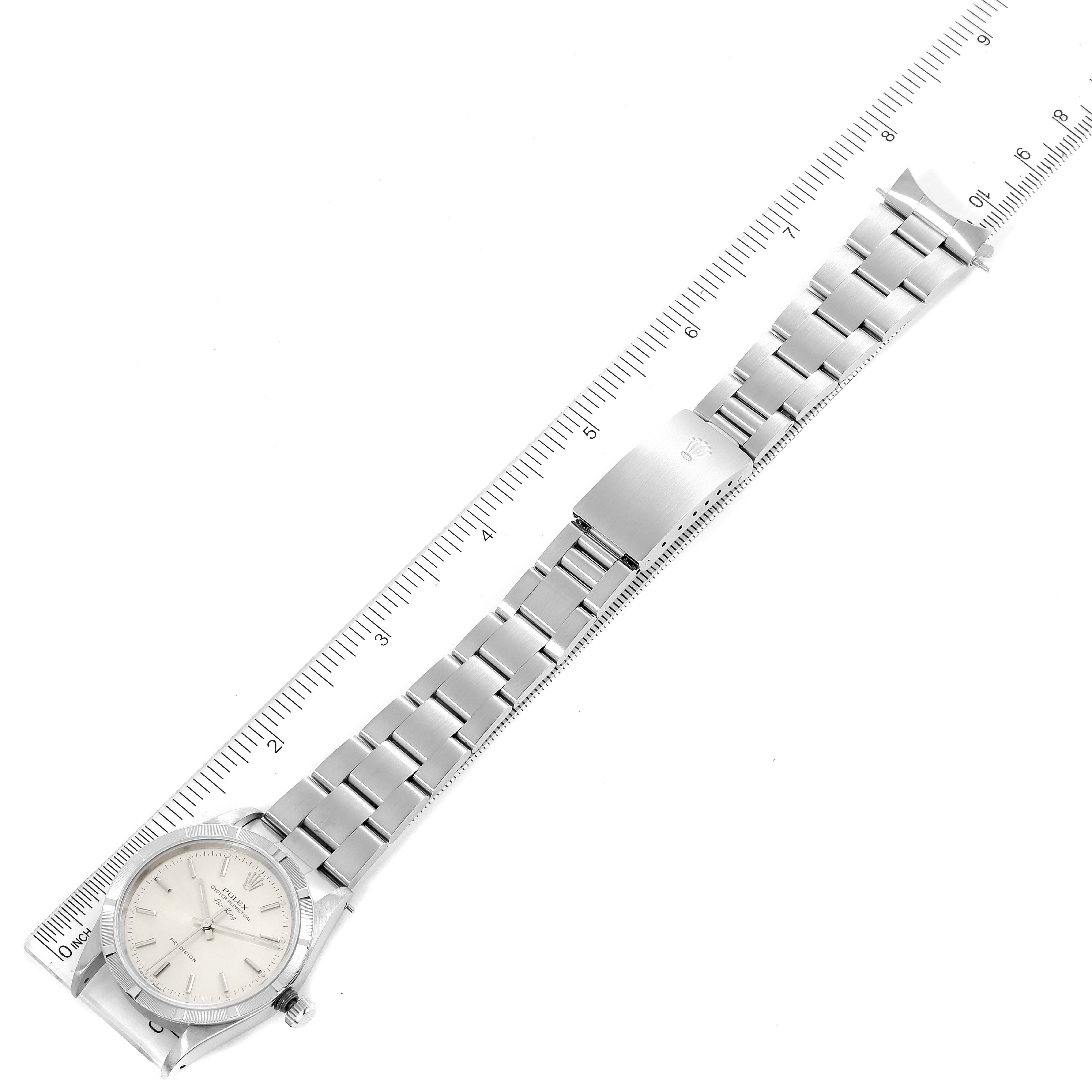 The image shows a Rolex Air-King 14010 Men's Stainless Steel Silver Dial 14010 Men's Stainless Steel Silver Dial watch laid flat with a ruler to measure its length, highlighting its face, bracelet, and clasp.