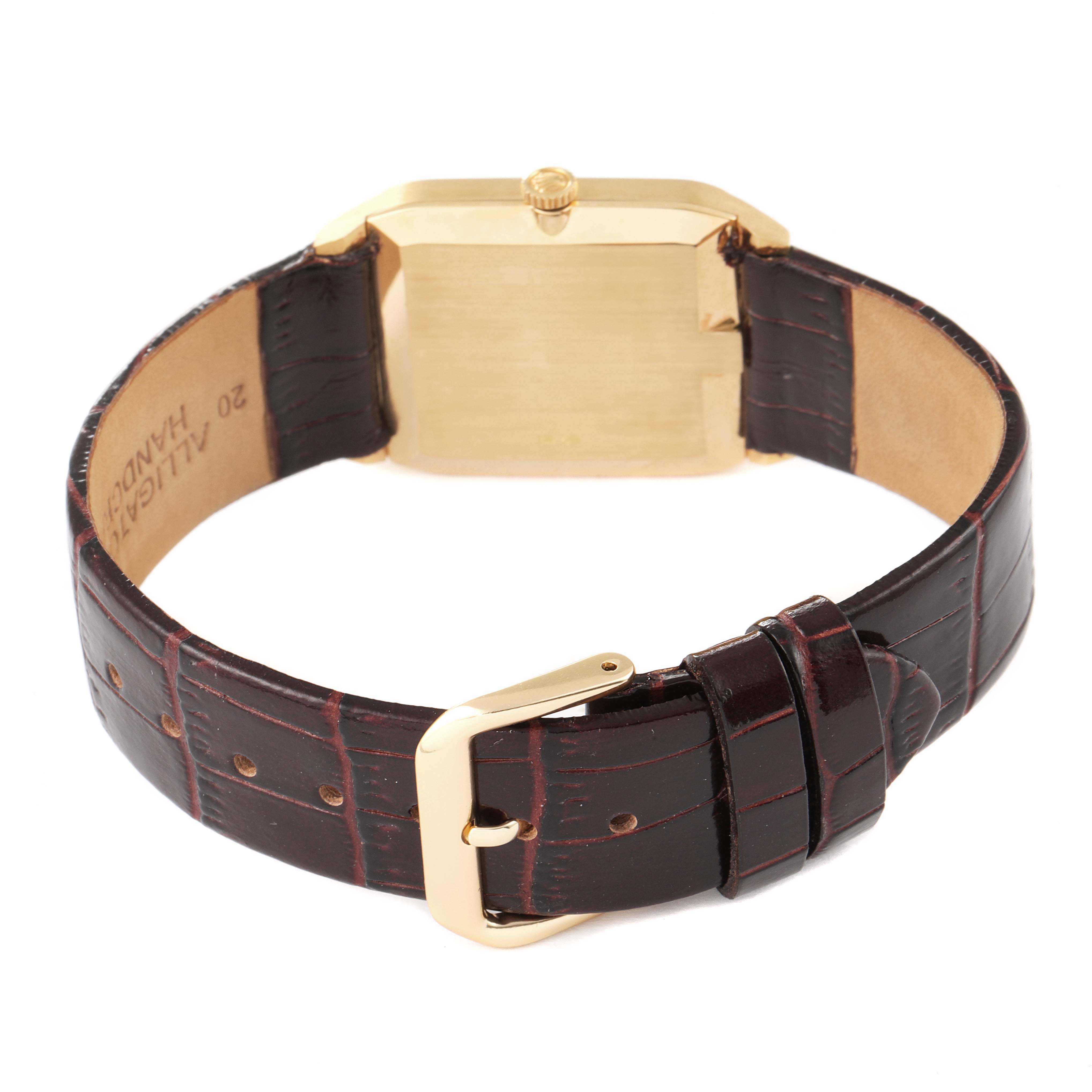 The image shows the back of a Rolex Cellini 4135 Men's Yellow Gold Champagne Dial 4135 Men's Yellow Gold Champagne Dial watch and its leather strap with a deployant buckle.