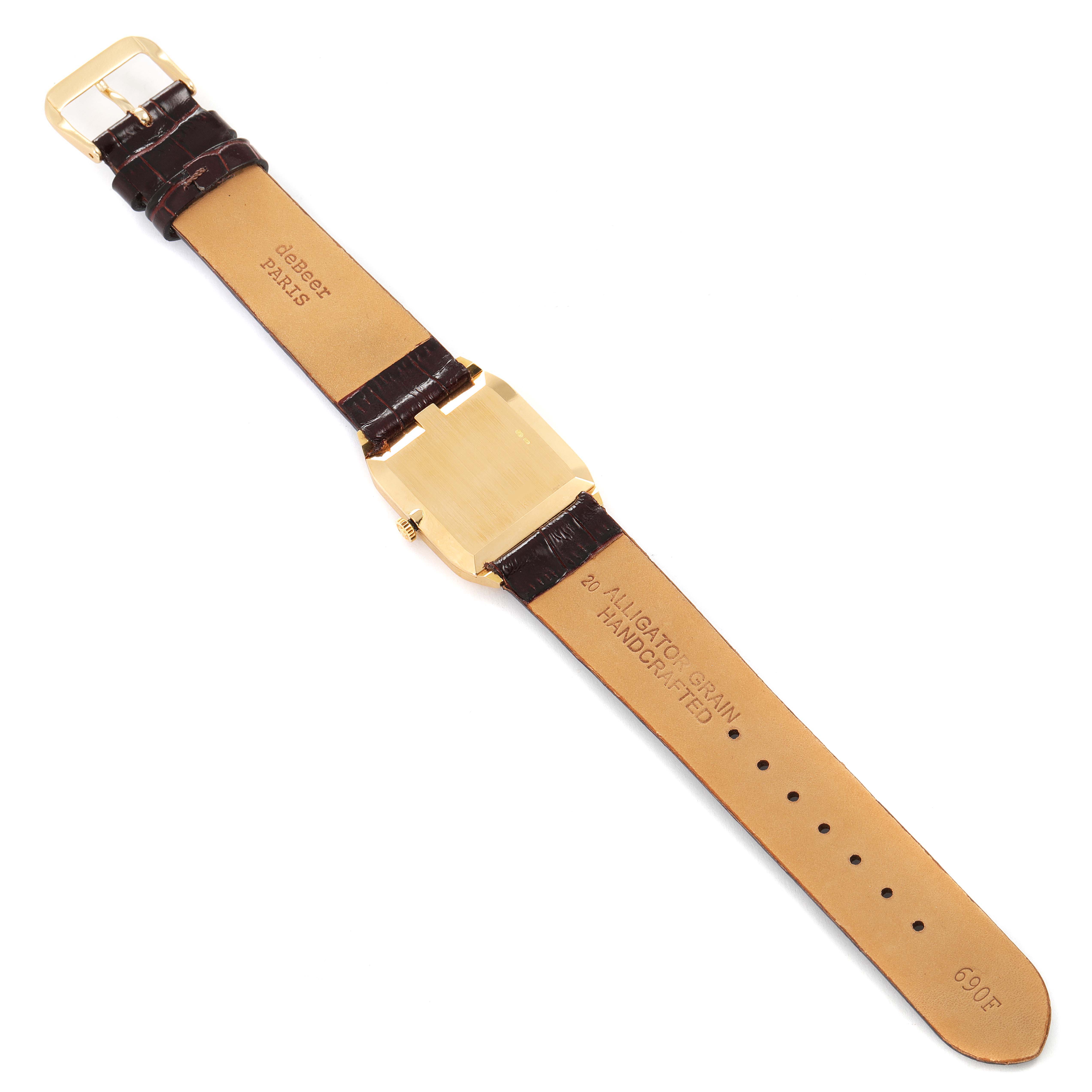 The image shows the backside of a Rolex Cellini 4135 Men's Yellow Gold Champagne Dial 4135 Men's Yellow Gold Champagne Dial watch laid flat, highlighting its leather strap and golden case.