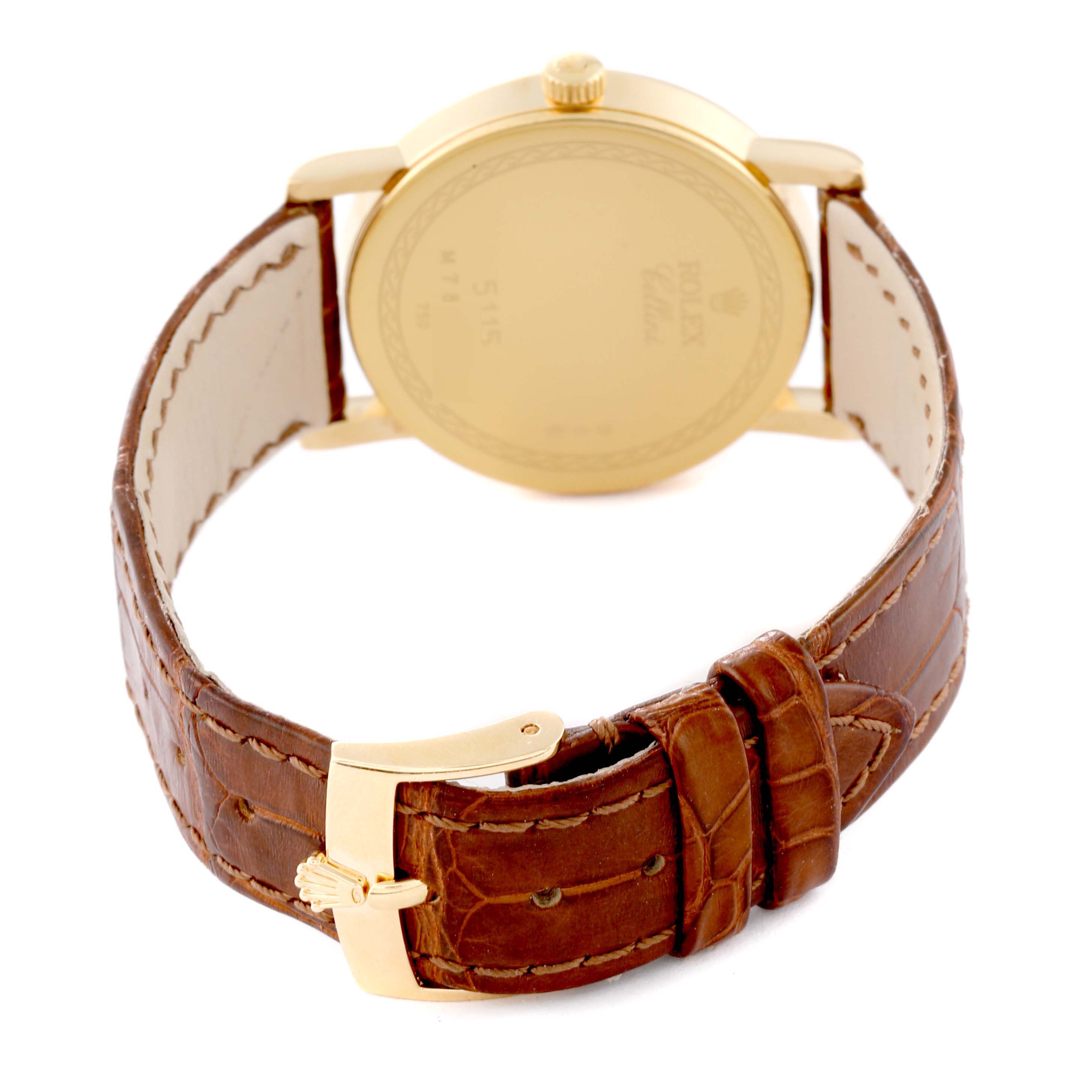 The image shows the back of a Rolex Cellini 5115 Men's Yellow Gold Champagne Dial 5115 Men's Yellow Gold Champagne Dial watch, highlighting the case back, crown, and brown leather strap with a gold buckle.