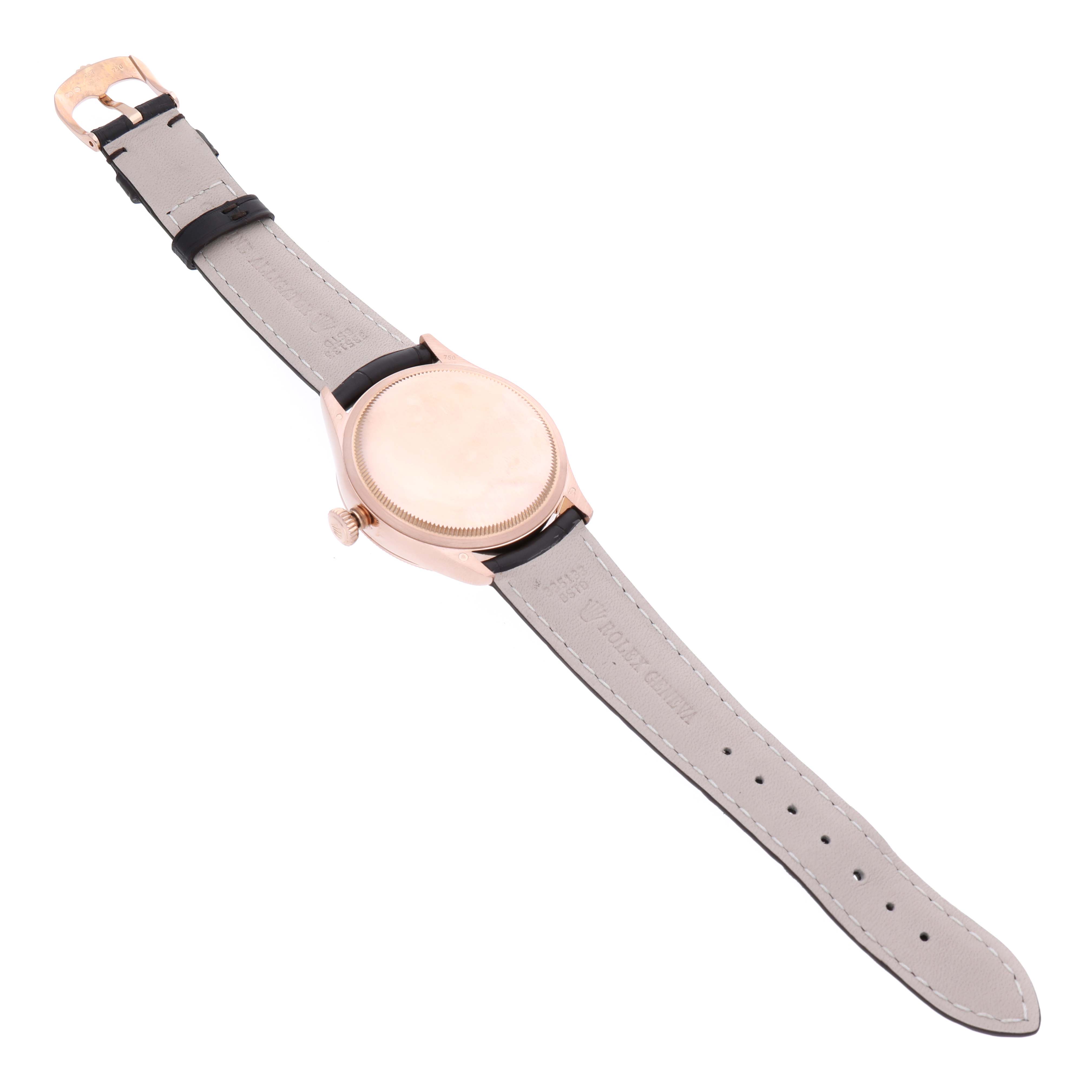 The image shows the back view of a Rolex Cellini 50515 Men's Rose Gold Silver Dial 50515 Men's Rose Gold Silver Dial watch with grey leather straps and a gold case.