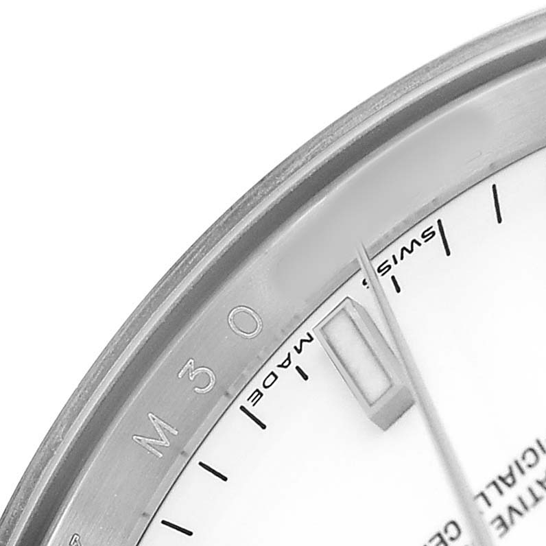 The image shows a close-up of the Rolex Date 115200 Men's Stainless Steel White Dial model's dial edge, including markers and "Swiss Made" text.