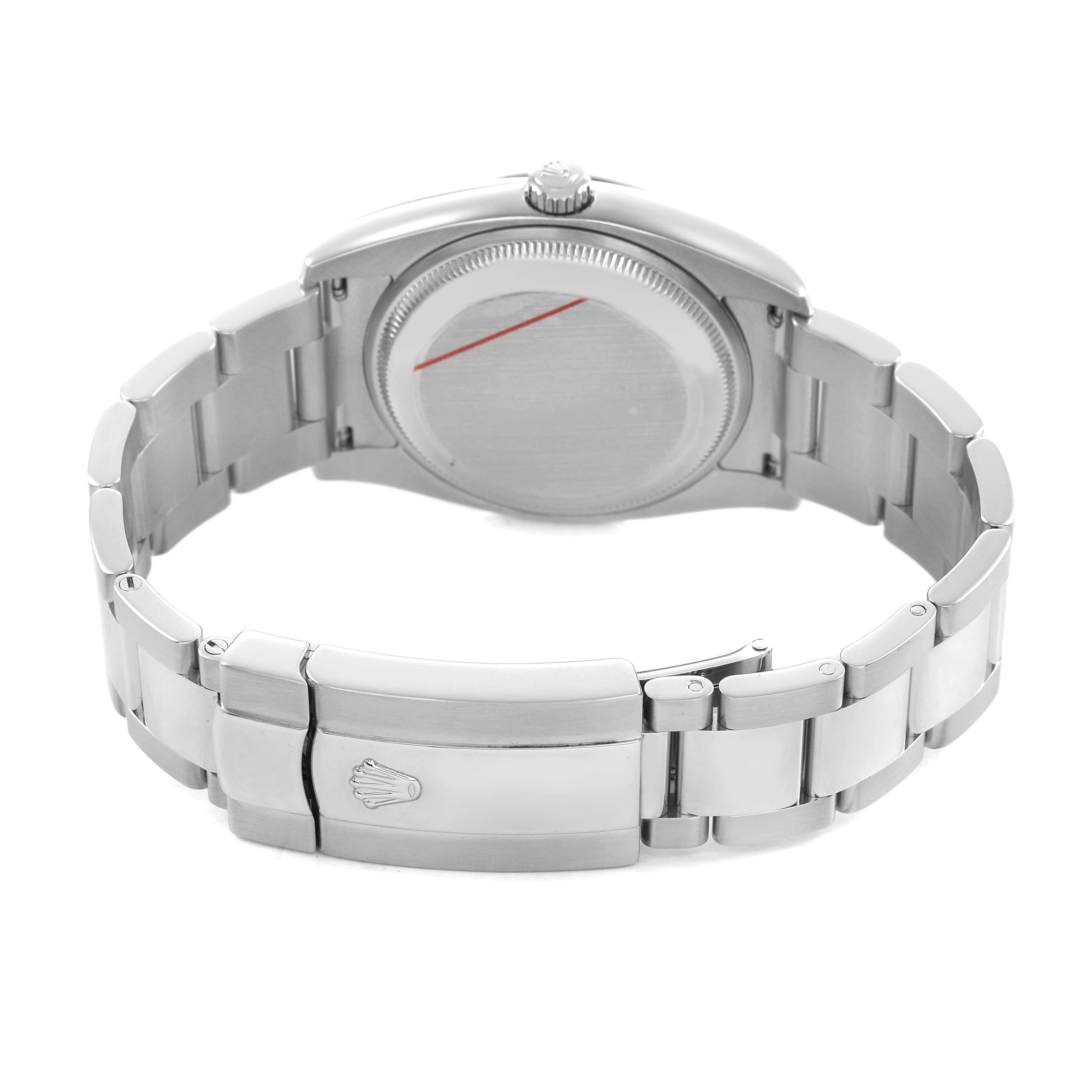 The image shows the back angle of a Rolex Date 115200 Men's Stainless Steel White Dial watch, highlighting its case back and bracelet clasp.