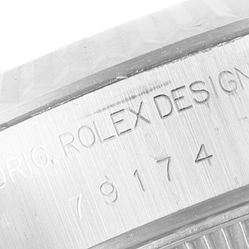 This close-up image shows the engraved details on the side of the bezel of a Rolex Datejust 79174 Women
s Stainless Steel Silver Dial 79174 Women
s Stainless Steel Silver Dial watch.