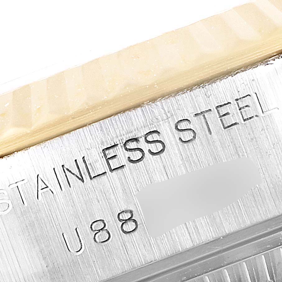 The image shows a close-up of the side of a Rolex Datejust 69173 Women
s Steel and Gold (two tone) Champagne Dial 69173 Women
s Steel and Gold (two tone) Champagne Dial watch made of stainless steel, highlighting its serial number.