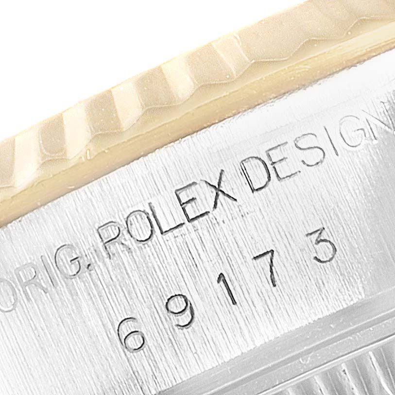 This close-up shows the fluted bezel and engraved casing of a Rolex Datejust 69173 Women
s Steel and Gold (two tone) Champagne Dial 69173 Women
s Steel and Gold (two tone) Champagne Dial watch.