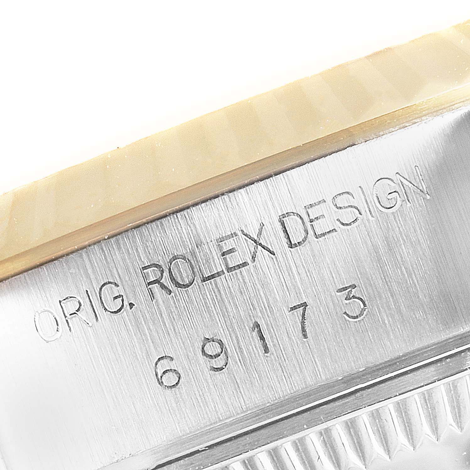 The close-up angle shows the side of the Rolex Datejust 69173 Women
s Steel and Gold (two tone) Champagne Dial 69173 Women
s Steel and Gold (two tone) Champagne Dial watch case with engraved design text and model number.