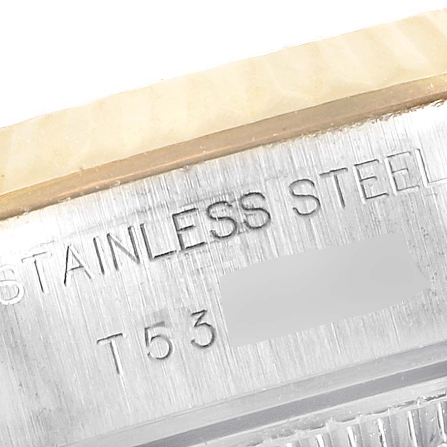 The image shows a close-up of the side view of a Rolex Datejust 69173 Women
s Steel and Gold (two tone) Champagne Dial 69173 Women
s Steel and Gold (two tone) Champagne Dial
s case, featuring a stainless steel engraving.