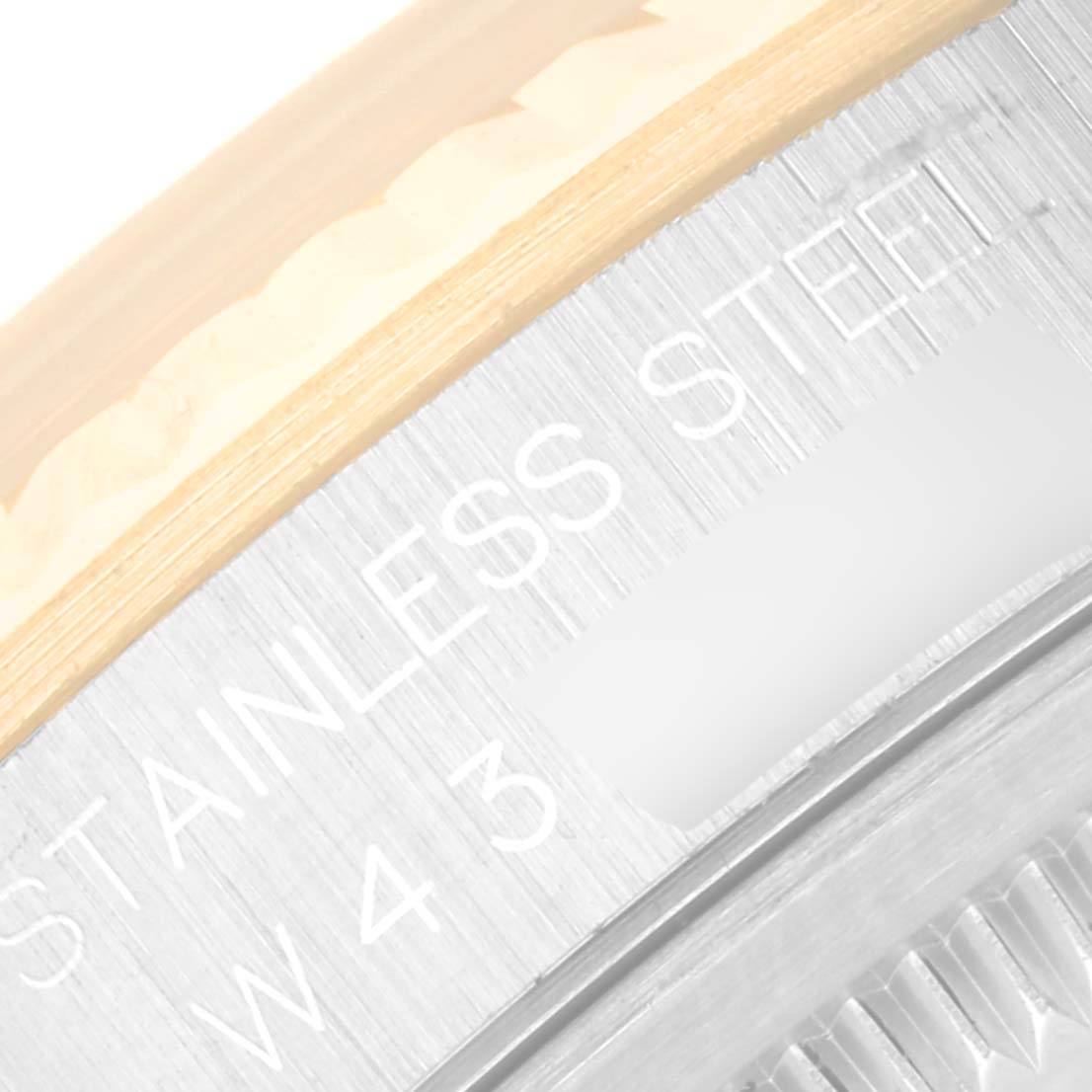 Close-up of the side casing of a Rolex Datejust 16233 Men's Steel and Gold (two tone) Champagne Dial 16233 Men's Steel and Gold (two tone) Champagne Dial watch, showing the "Stainless Steel" engraving.