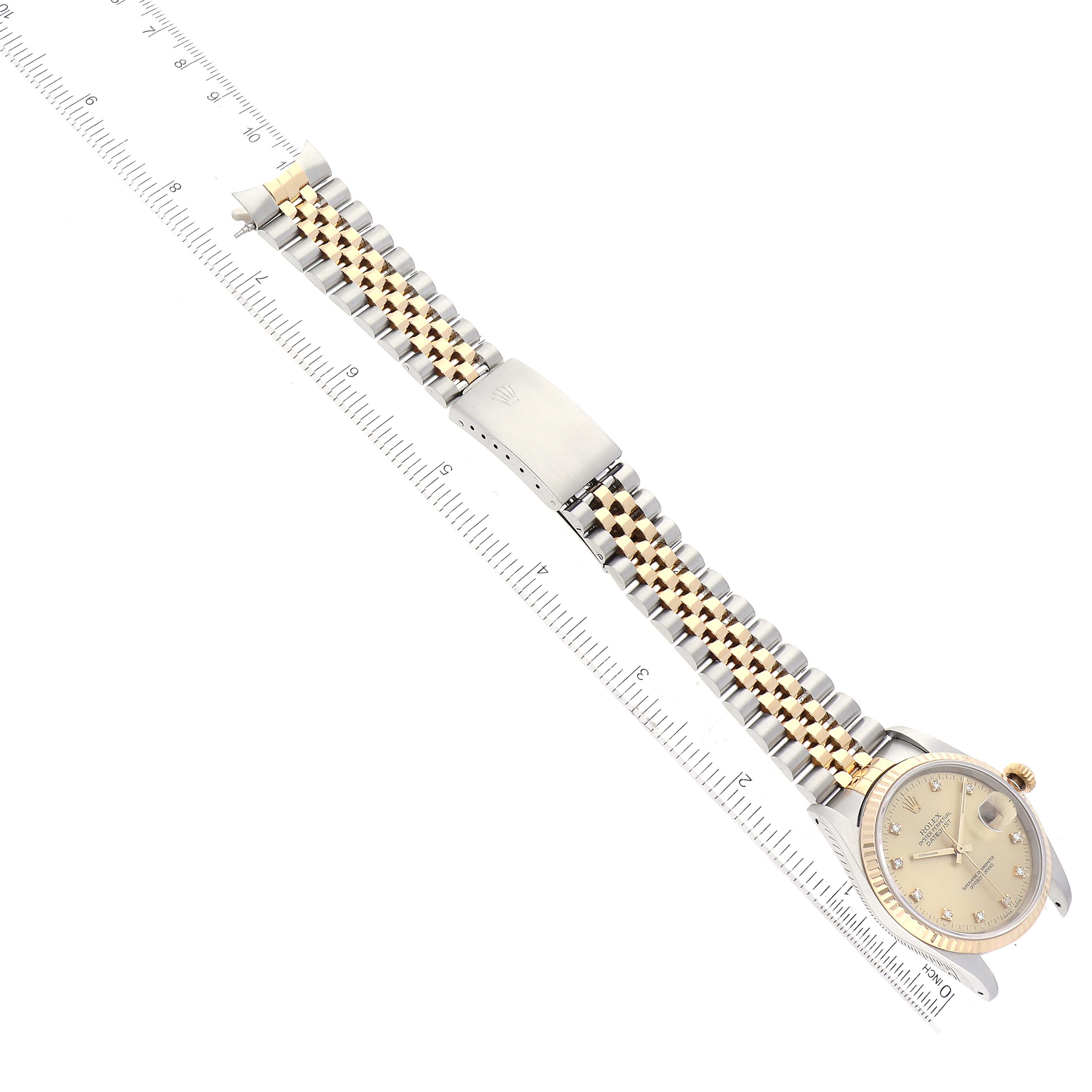 The image shows a Rolex Datejust 16233 Men's Steel and Gold (two tone) Champagne Dial 16233 Men's Steel and Gold (two tone) Champagne Dial watch lying flat with a two-tone bracelet and clasp measured next to a ruler.