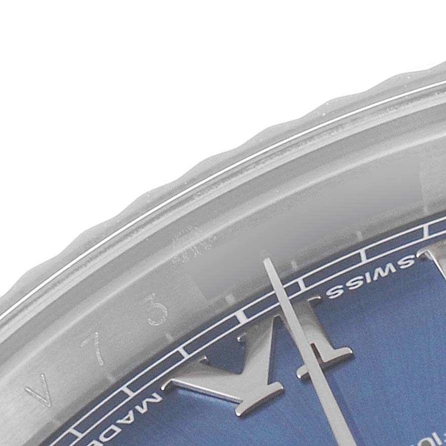 This image shows a close-up of the Rolex Datejust 41 116334 Men
s Stainless Steel Blue Dial 116334 Men
s Stainless Steel Blue Dial watch, highlighting the bezel, part of the dial, and minute hand.