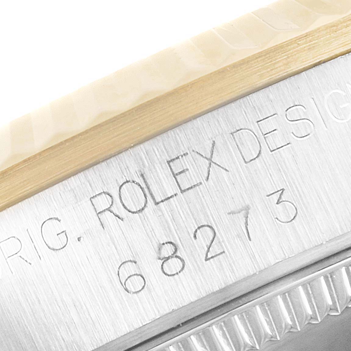 This image shows a close-up of the Rolex Mid-Size 68273 Women's Steel and Gold (two tone) Champagne Dial 68273 Women's Steel and Gold (two tone) Champagne Dial model's bezel and engraved serial number.