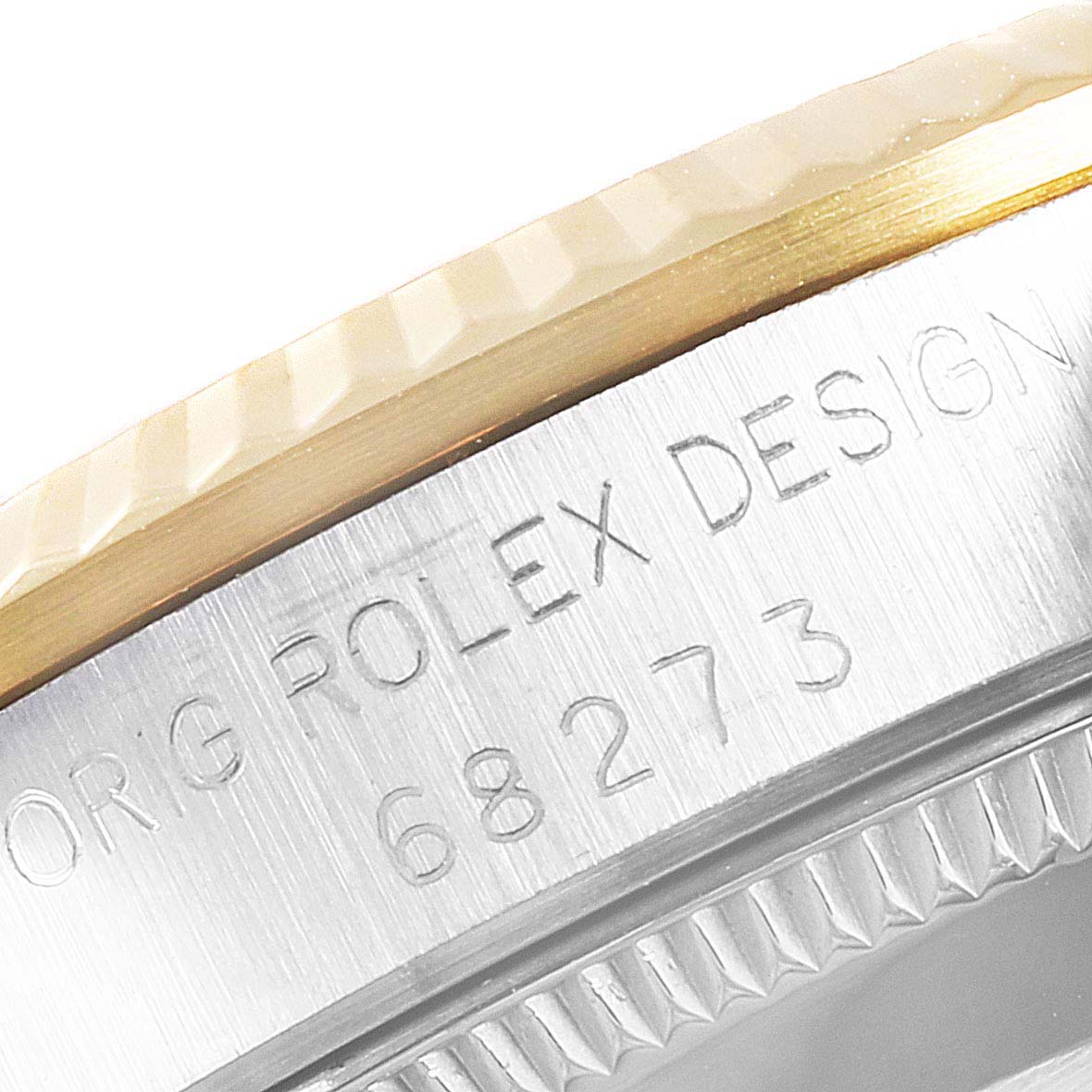 This image shows a close-up of the side of a Mid-Size Rolex watch, featuring the engraved model number and part of the bezel.