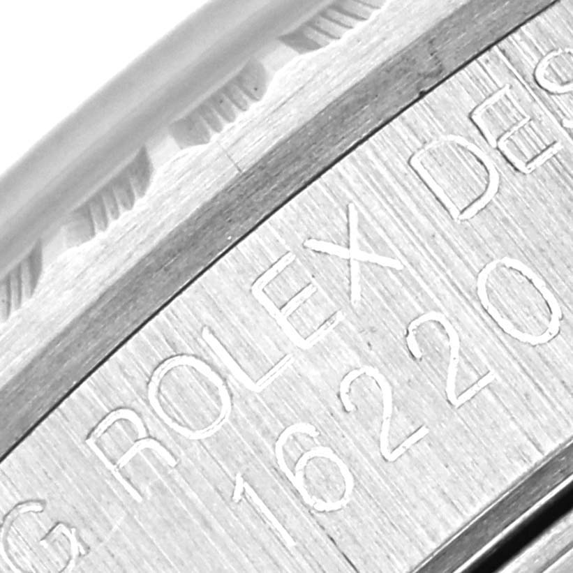 Close-up of the engraved case edge of a Rolex Datejust 16220 Men's Stainless Steel Silver Dial 16220 Men's Stainless Steel Silver Dial, showing model details and part of the bezel.