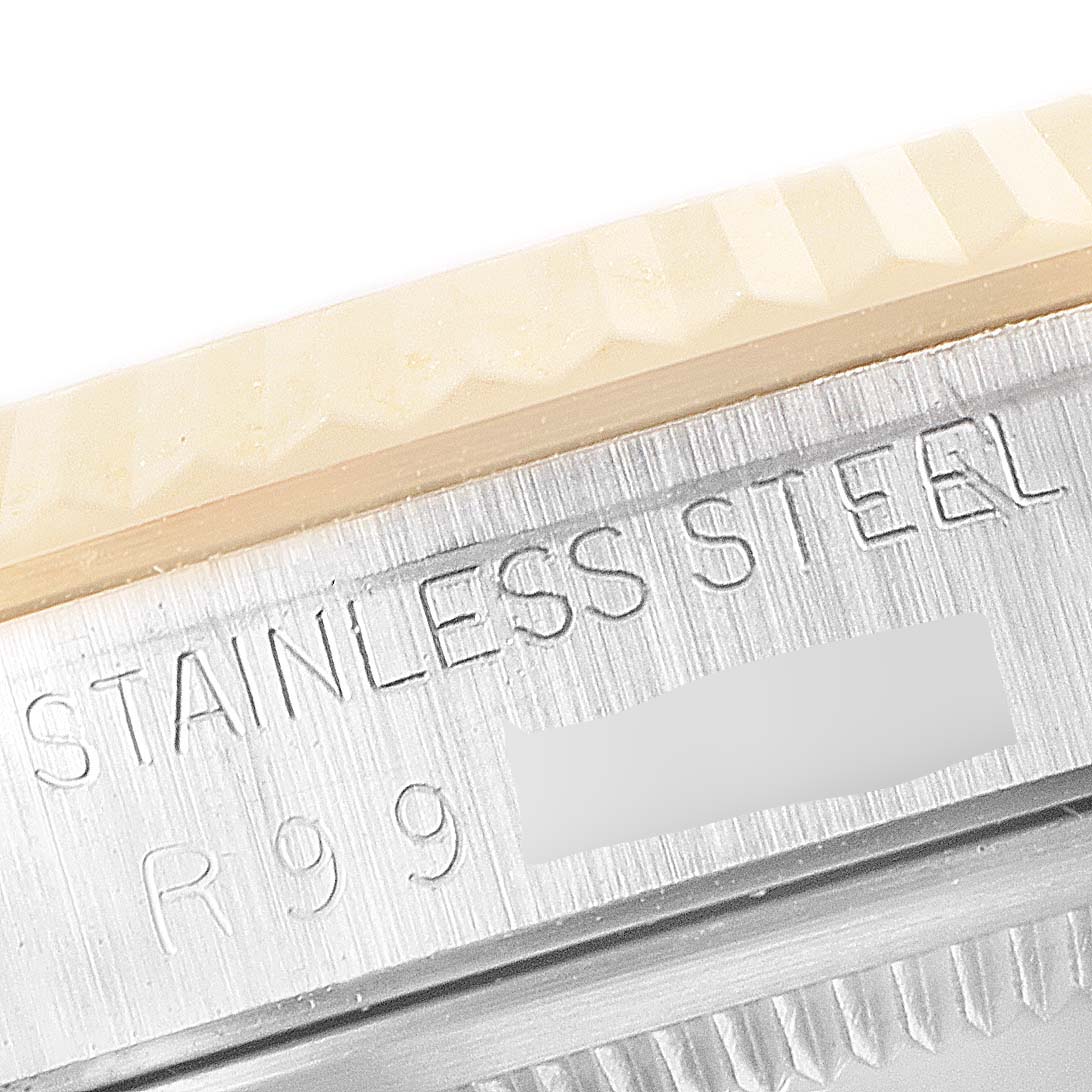 This close-up image shows the stainless steel bezel and part of the engraving on a Rolex Datejust 16233 Men's Steel and Gold (two tone) Champagne Dial 16233 Men's Steel and Gold (two tone) Champagne Dial watch.