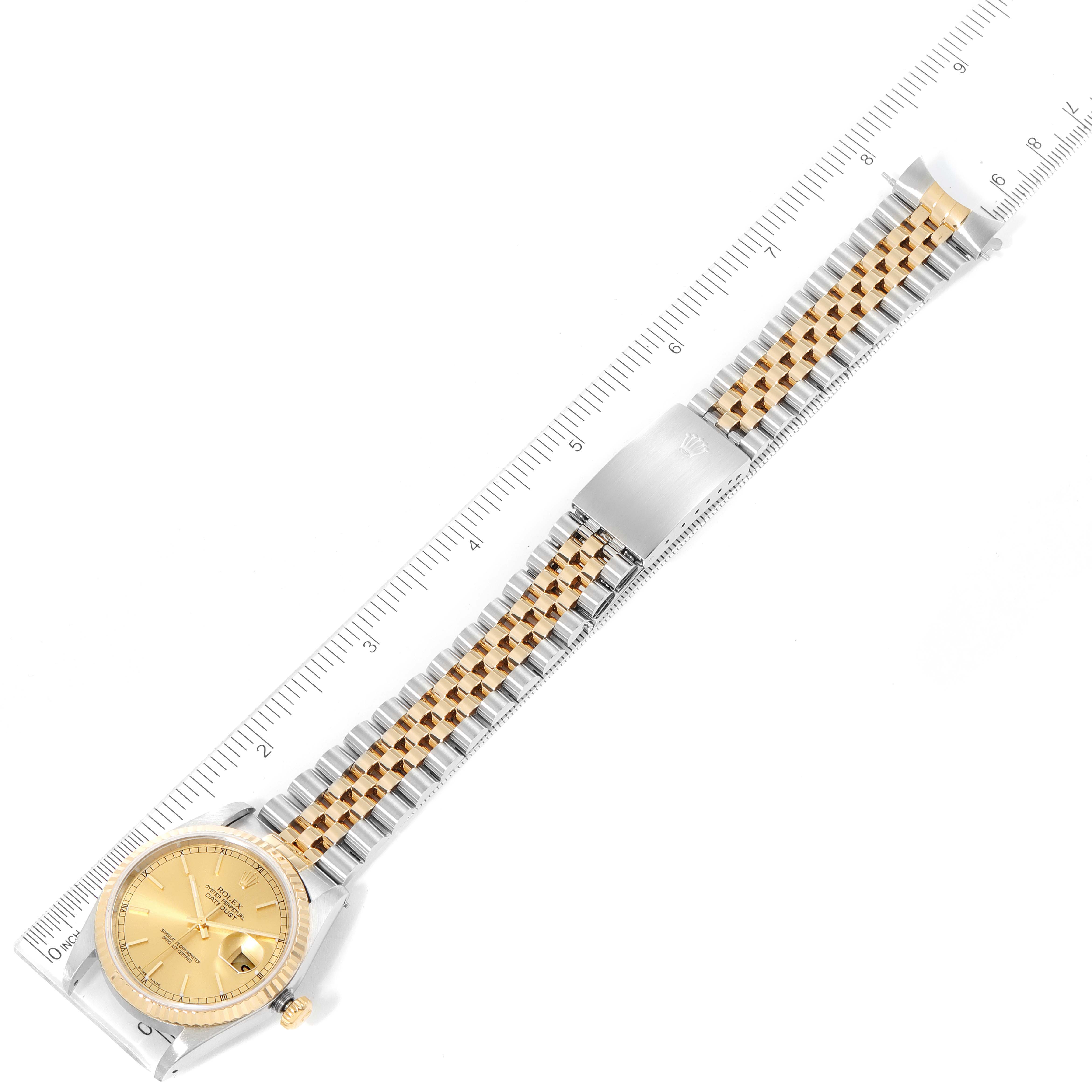 The Rolex Datejust 16233 Men's Steel and Gold (two tone) Champagne Dial 16233 Men's Steel and Gold (two tone) Champagne Dial watch is shown from a top-down angle, displaying the entire bracelet and dial with a ruler beside it for scale.