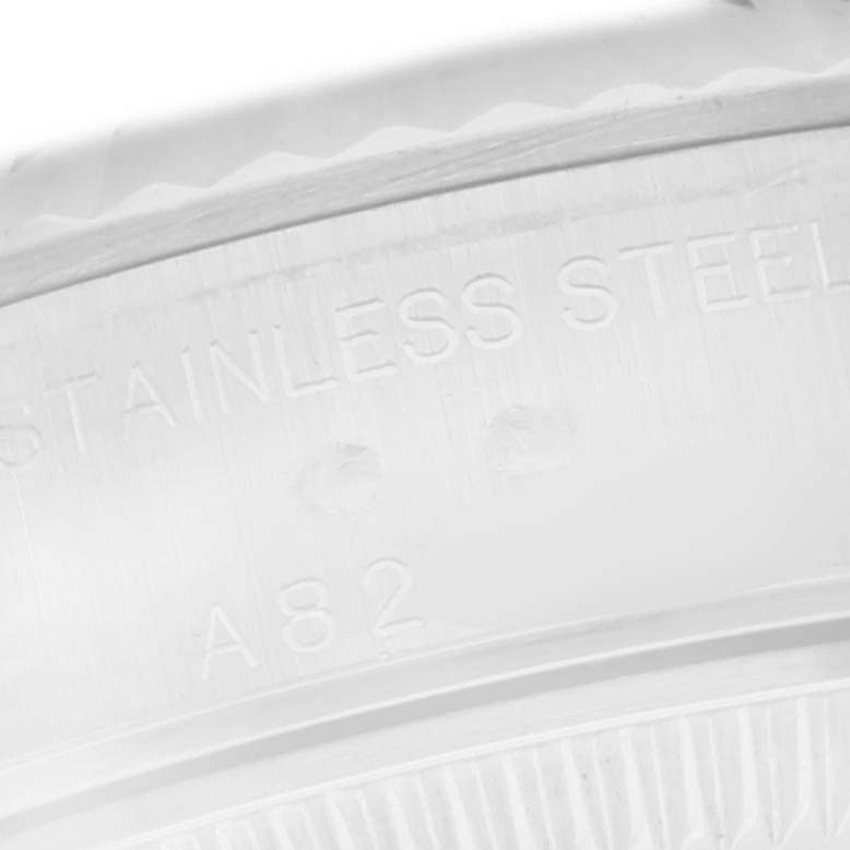 The image shows a close-up of the Rolex Datejust 79174 Women
s Stainless Steel Silver Dial 79174 Women
s Stainless Steel Silver Dial
s case with "Stainless Steel" engraved on it.