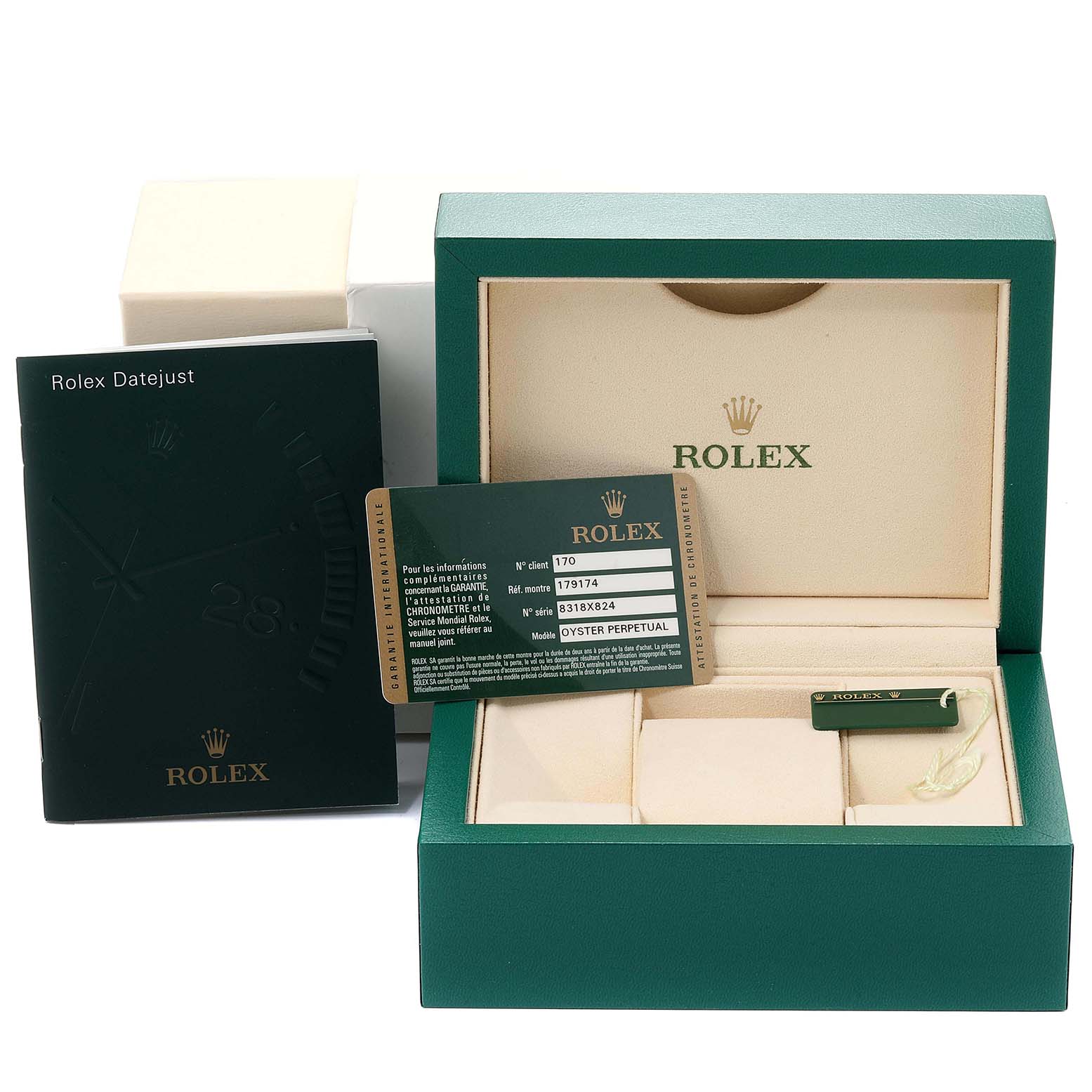 The image shows the packaging and accessories for a Rolex Datejust 179174  Women
s Stainless Steel Black Dial 179174  Women
s Stainless Steel Black Dial watch, including the box, manual, tag, and guarantee card.