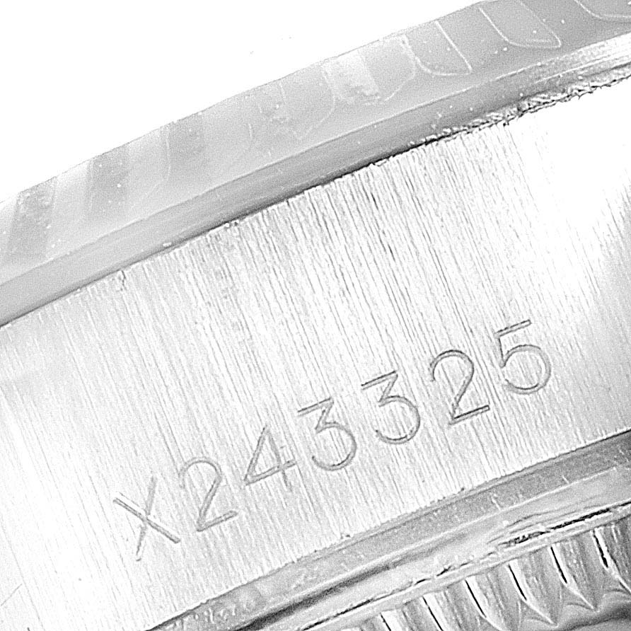 This image shows a close-up of the serial number on the case of a Rolex Datejust 69174 Women
s Stainless Steel Silver Dial 69174 Women
s Stainless Steel Silver Dial watch.