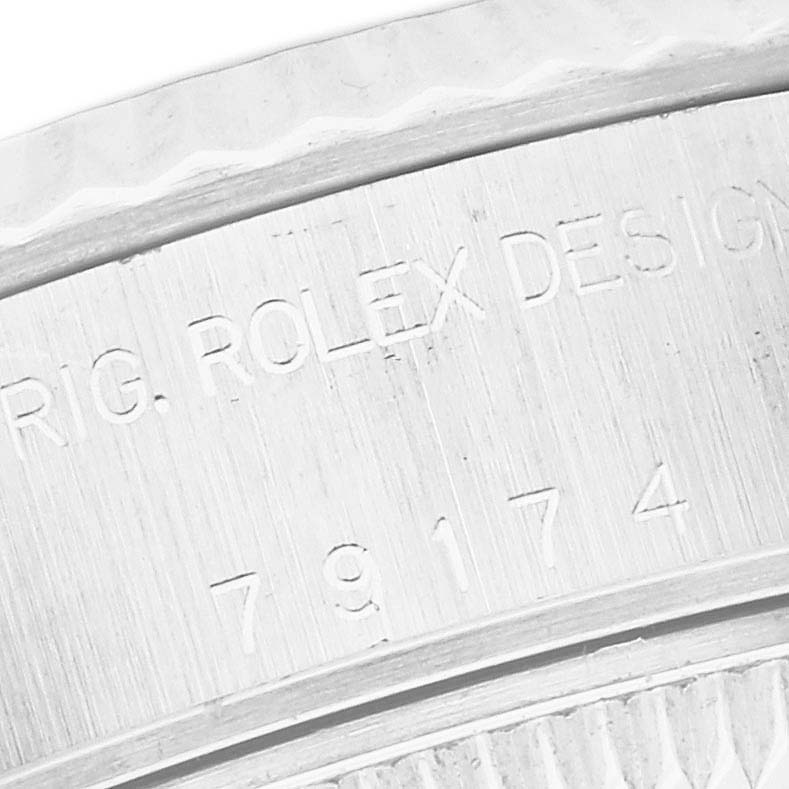 The image shows the side profile of a Rolex Datejust 79174 Women
s Stainless Steel Mother of Pearl Dial 79174 Women
s Stainless Steel Mother of Pearl Dial, focusing on its engraved case numbers and markings.