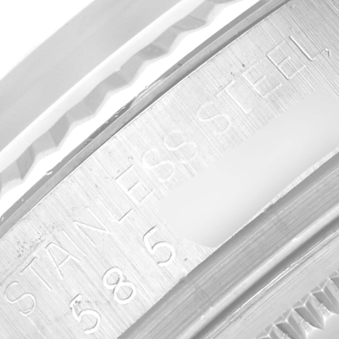 This image shows a close-up view of the stainless steel bezel and serial number area of a Rolex Datejust 16014 Men's Stainless Steel Silver Dial 16014 Men's Stainless Steel Silver Dial watch.