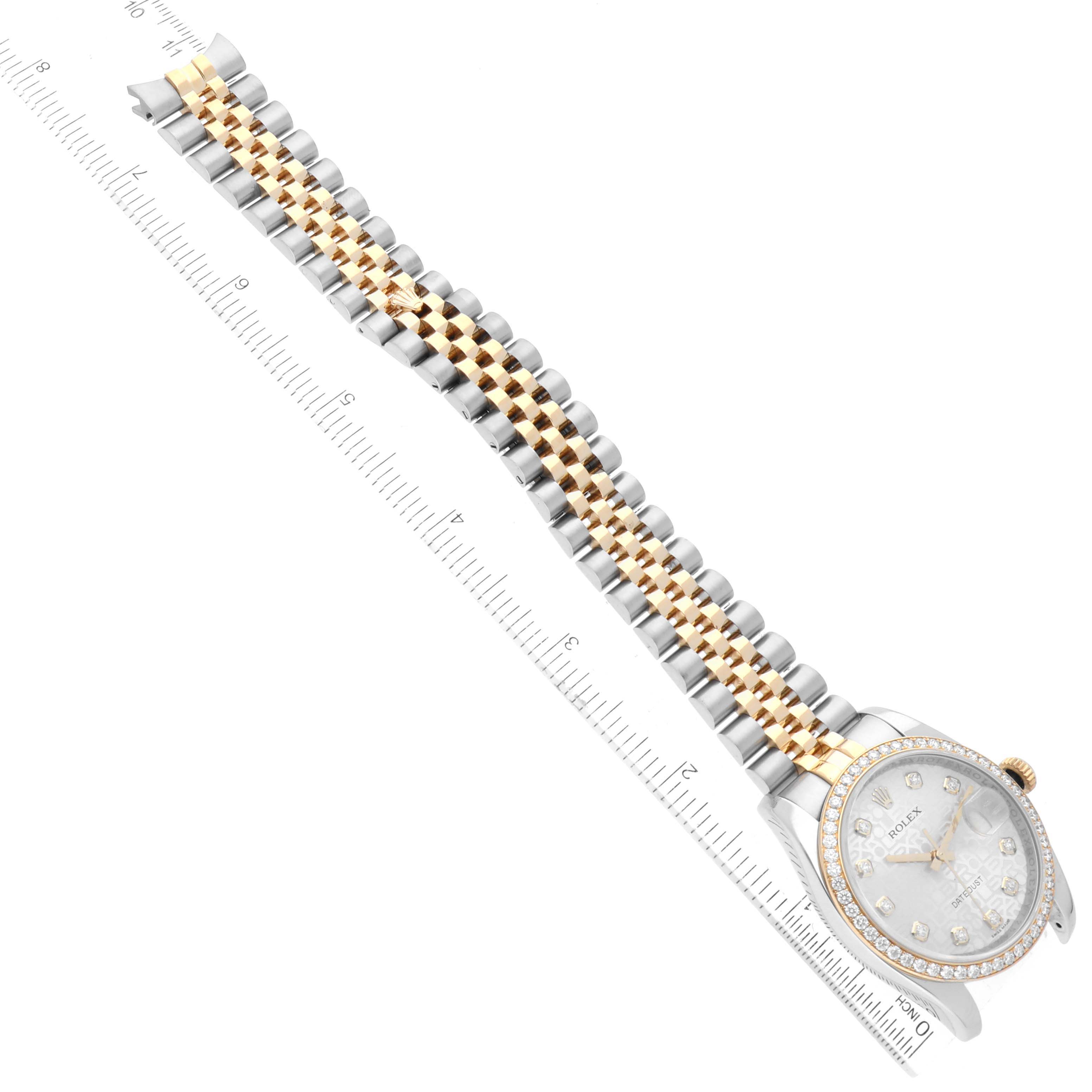 The image shows a Rolex Datejust 116243 Men
s Steel and Gold (two tone) Silver Dial 116243 Men
s Steel and Gold (two tone) Silver Dial model watch lying flat, highlighting its face and two-tone metal bracelet beside a ruler for scale.