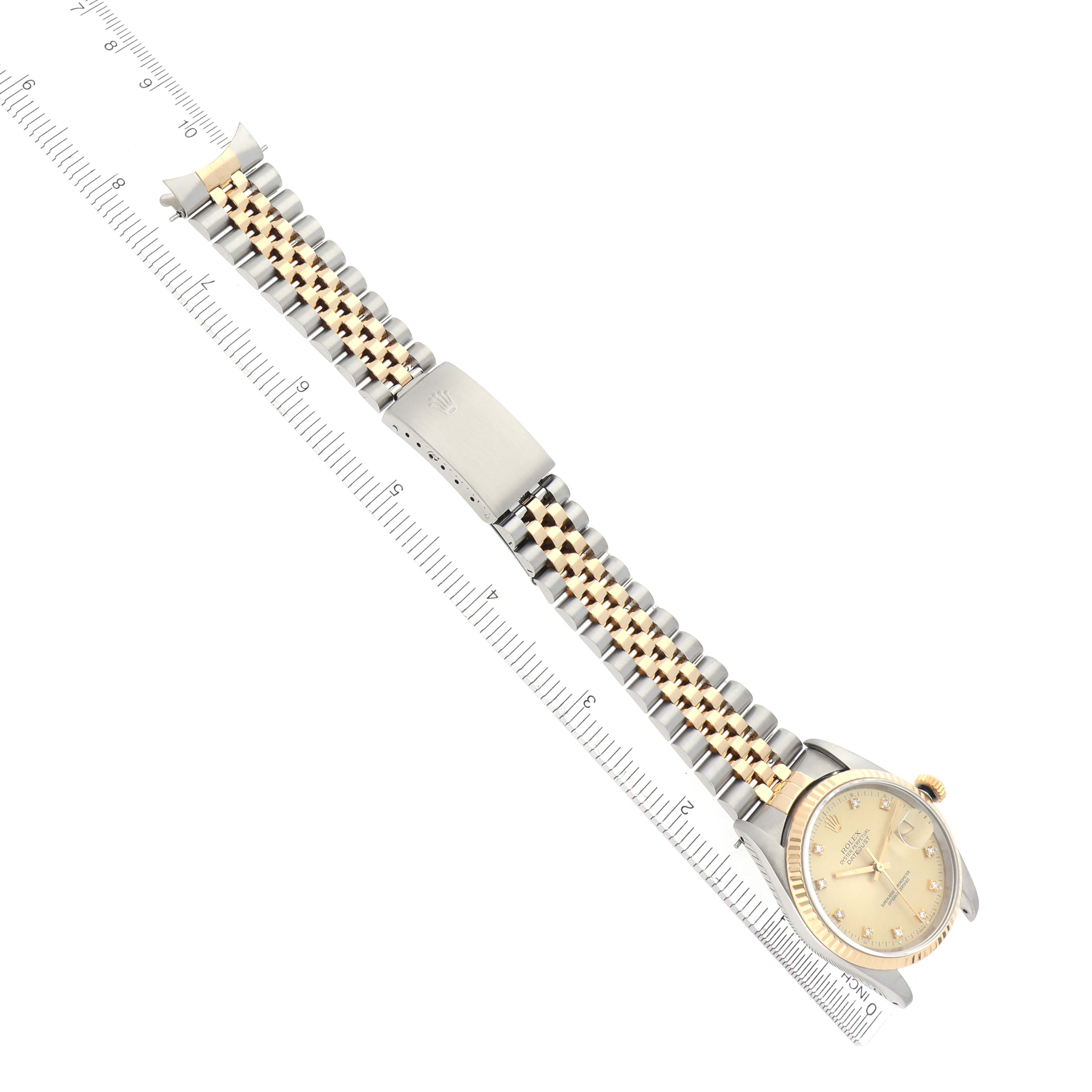The Rolex Datejust 16233 Men
s Steel and Gold (two tone) Champagne Dial 16233 Men
s Steel and Gold (two tone) Champagne Dial watch is shown from an overhead angle, displaying the full bracelet, clasp, and dial.