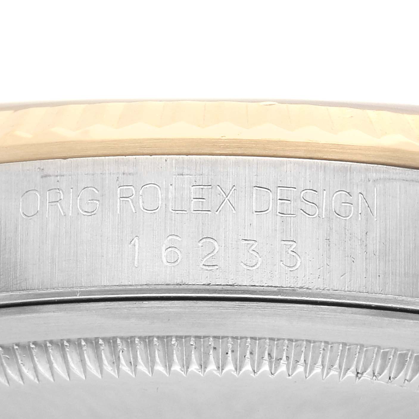 The image shows a close-up of the Rolex Datejust 16233 Men
s Steel and Gold (two tone) Champagne Dial 16233 Men
s Steel and Gold (two tone) Champagne Dial model
s side, highlighting the engraving "ORIG ROLEX DESIGN 16233" on the case.